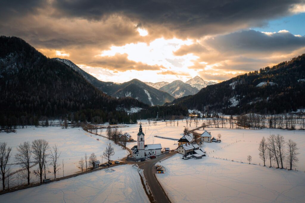 Aerial view of Church over Zgornje Jezersko, Slovenia in winter with snow. Travel and tourism.,Image: 965864975, License: Royalty-free, Restrictions: , Model Release: no, Credit line: 24K-Production / Alamy / Profimedia