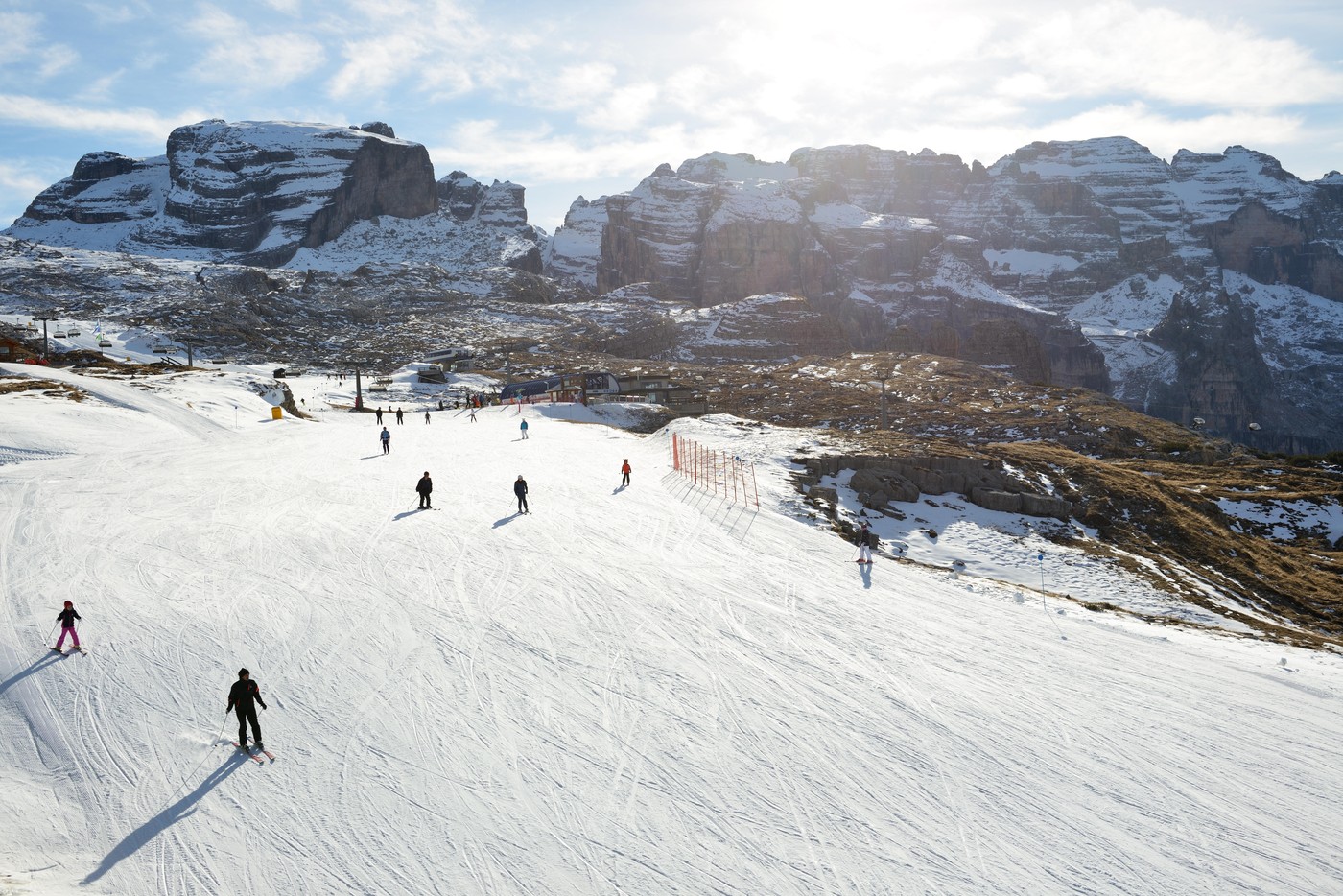 The ski slope and skiers at Passo Groste ski area, Madonna di Campiglio, Italy