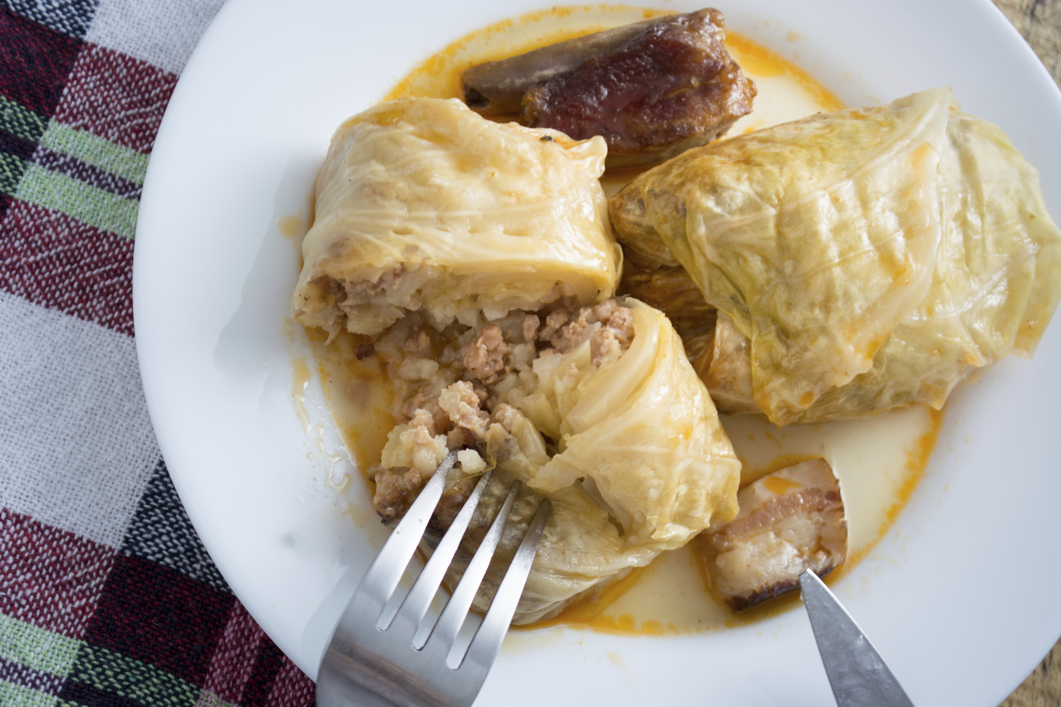 Serbian sarma (stuffed cabbage rolls) served on the white plate on wooden table,Image: 994724656, License: Royalty-free, Restrictions: , Model Release: no, Credit line: Dragomir Radovanovic / imageBROKER / Profimedia