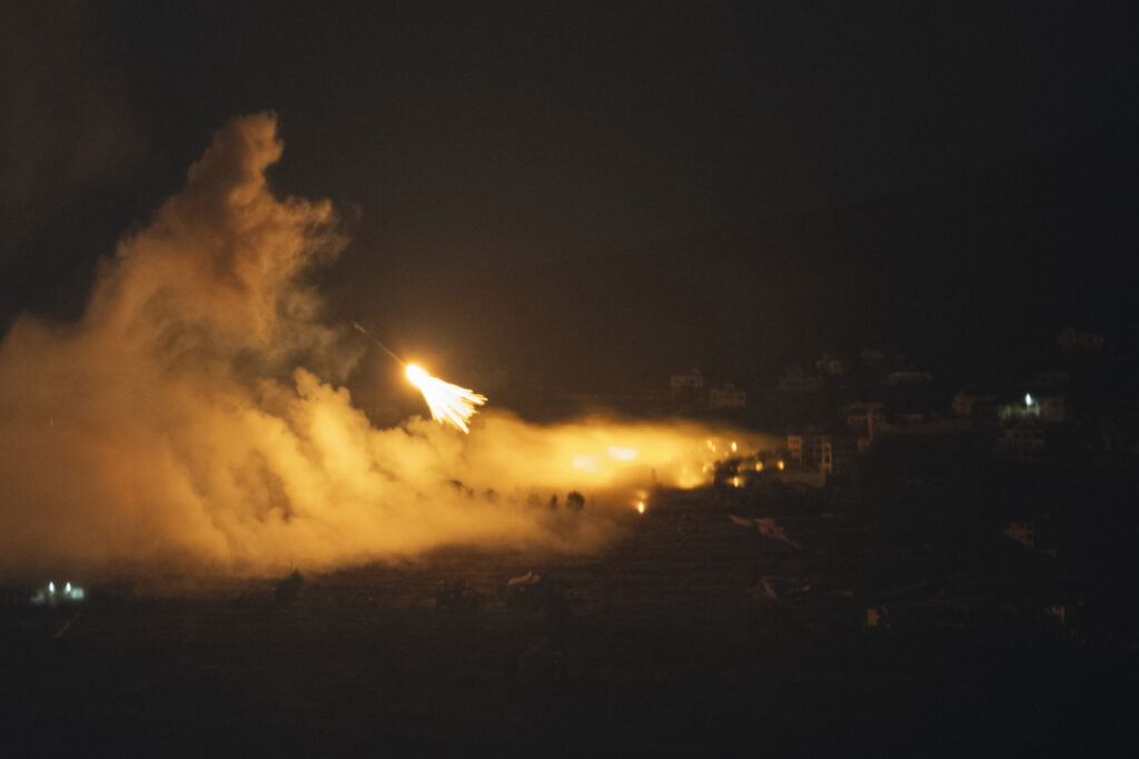 Israeli shelling hit an area in southern Lebanon as seen from northern Israel, early Tuesday, Oct. 1, 2024. (AP Photo/Leo Correa)
