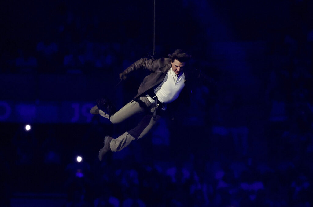 Actor Tom Cruise jumps from the roof of the Stade de France during the closing ceremony of the 2024 Summer Olympics, Sunday, Aug. 11, 2024, in Saint-Denis, France. (Fabrizio Bensch/Pool Photo via AP)