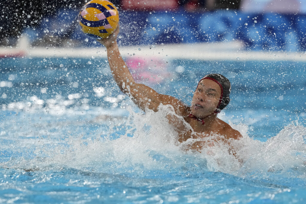 Japan's Daichi Ogihara makes an attempt to score during the men's Water Polo Group B preliminary match between Serbia and Japan at the 2024 Summer Olympics, Sunday, July 28, 2024, in Saint-Denis, France. (AP Photo/Luca Bruno)