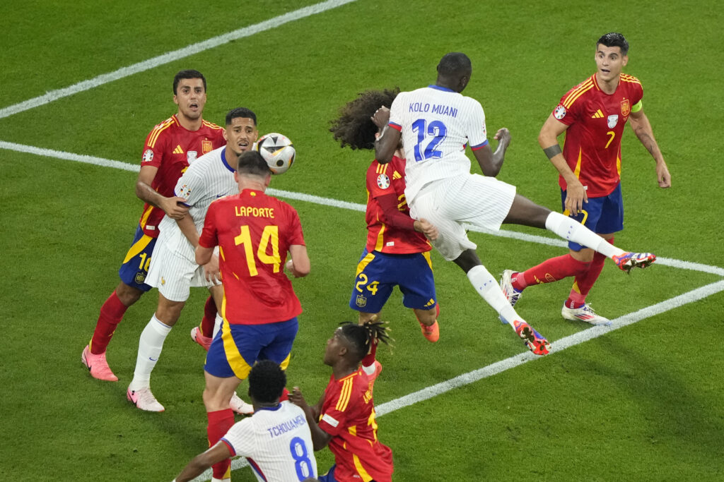 Randal Kolo Muani of France (12) jumps for a header during a semifinal match between Spain and France at the Euro 2024 soccer tournament in Munich, Germany, Tuesday, July 9, 2024. (AP Photo/Ebrahim Noroozi)