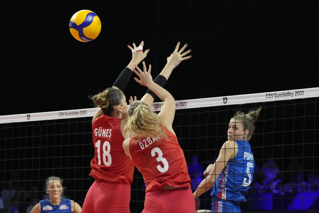 Turkey's Zehra Gunes and Turkey's Cansu Ozbay go up for a block during the Women's European Volleyball Championship final match between Serbia and Turkey in Brussels, Belgium, Sunday, Sept. 3, 2023. (AP Photo/Virginia Mayo)
