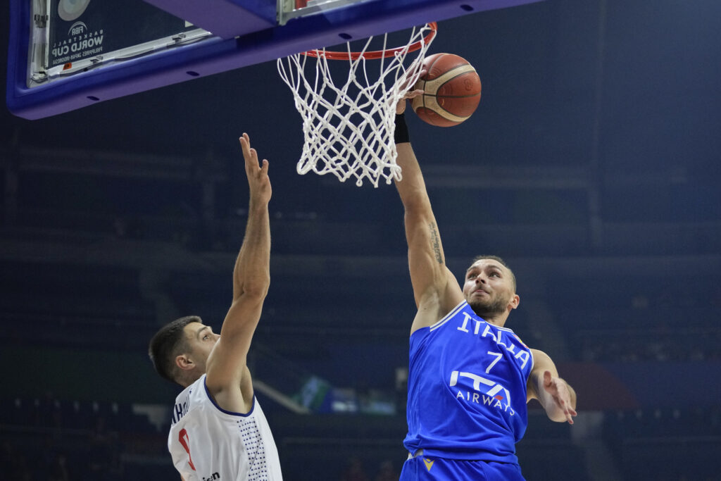 Italy guard Stefano Tonut (7) shoots over Serbia guard Vanja Marinkovic (9) during the Basketball World Cup second round match at the Araneta Coliseum, Manila, Philippines, Friday, Aug. 1, 2023. (AP Photo/Aaron Favila)