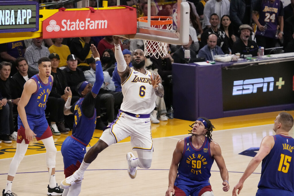 Los Angeles Lakers forward LeBron James (6) scores past Denver Nuggets forward Aaron Gordon (50) in the first half of Game 3 of the NBA basketball Western Conference Final series Saturday, May 20, 2023, in Los Angeles. (AP Photo/Mark J. Terrill)
