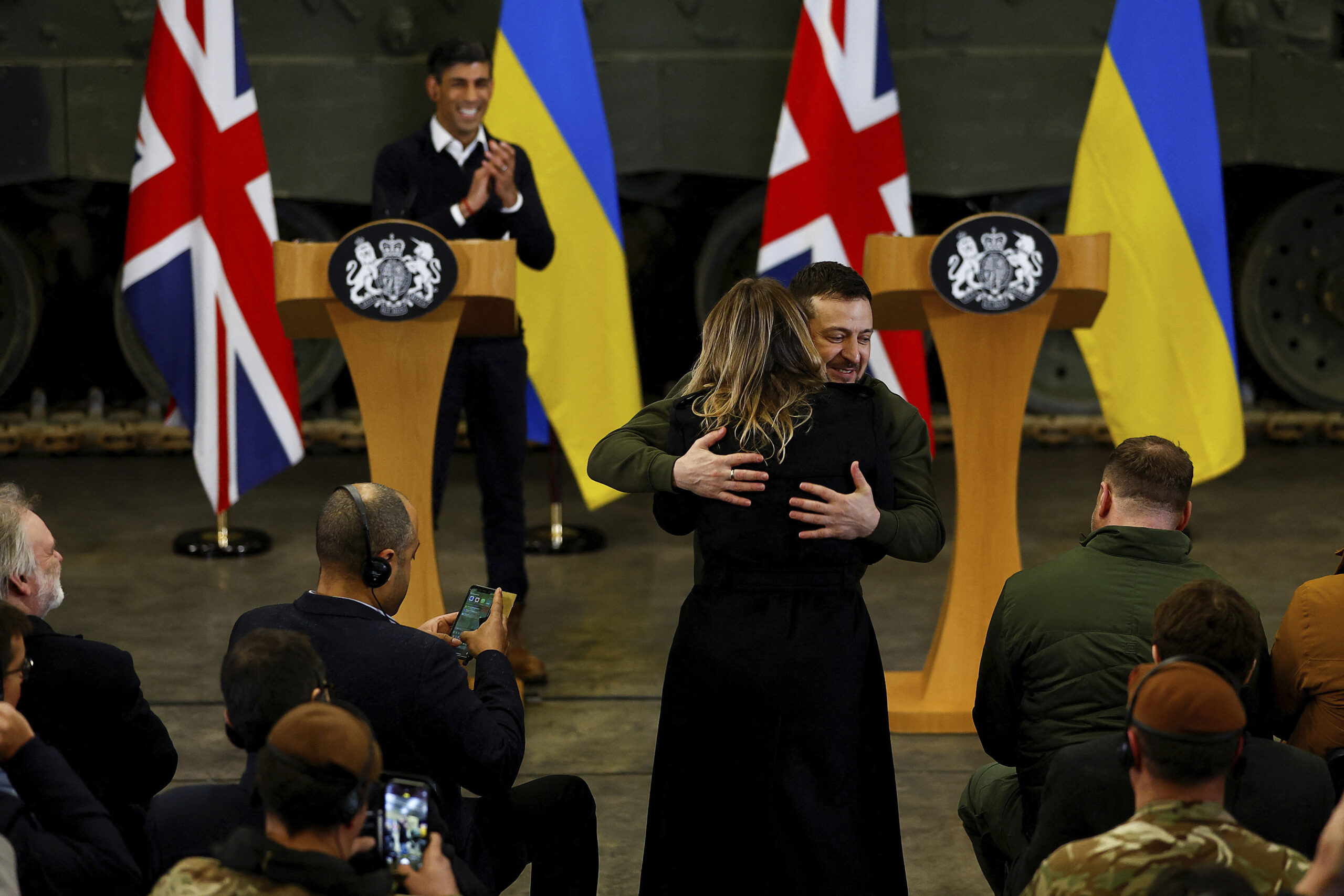 Ukrainian President Volodymyr Zelenskyy hugs a journalist while at a news conference with British Prime Minister Rishi Sunak at a military facility in Lulworth, Dorset, England, Wednesday Feb. 8, 2023. (Peter Nicholls/Pool via AP)