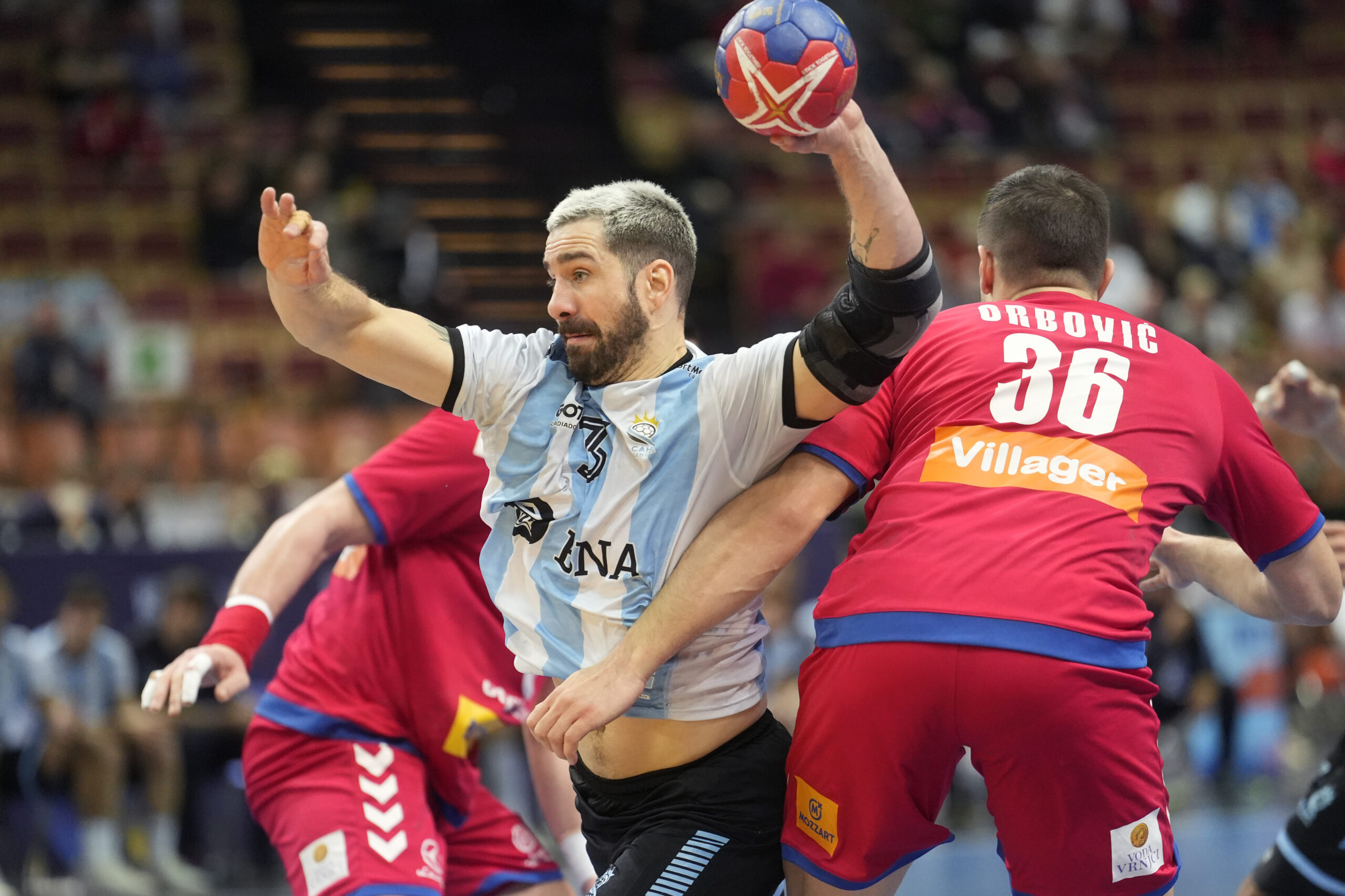 Argentina's Federico Pizarro, centre, in action during the Main Round Group III, Handball World Championship match between Serbia and Argentina in Katowice, Poland, Saturday, Jan. 21, 2023. (AP Photo/Piotr Hawalej)