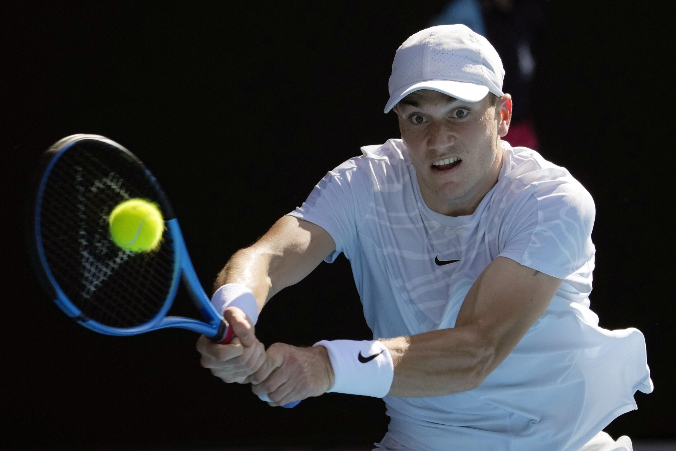 Jack Draper of Britain plays a backhand return to Rafael Nadal of Spain during their first round match at the Australian Open tennis championship in Melbourne, Australia, Monday, Jan. 16, 2023. (AP Photo/Aaron Favila)