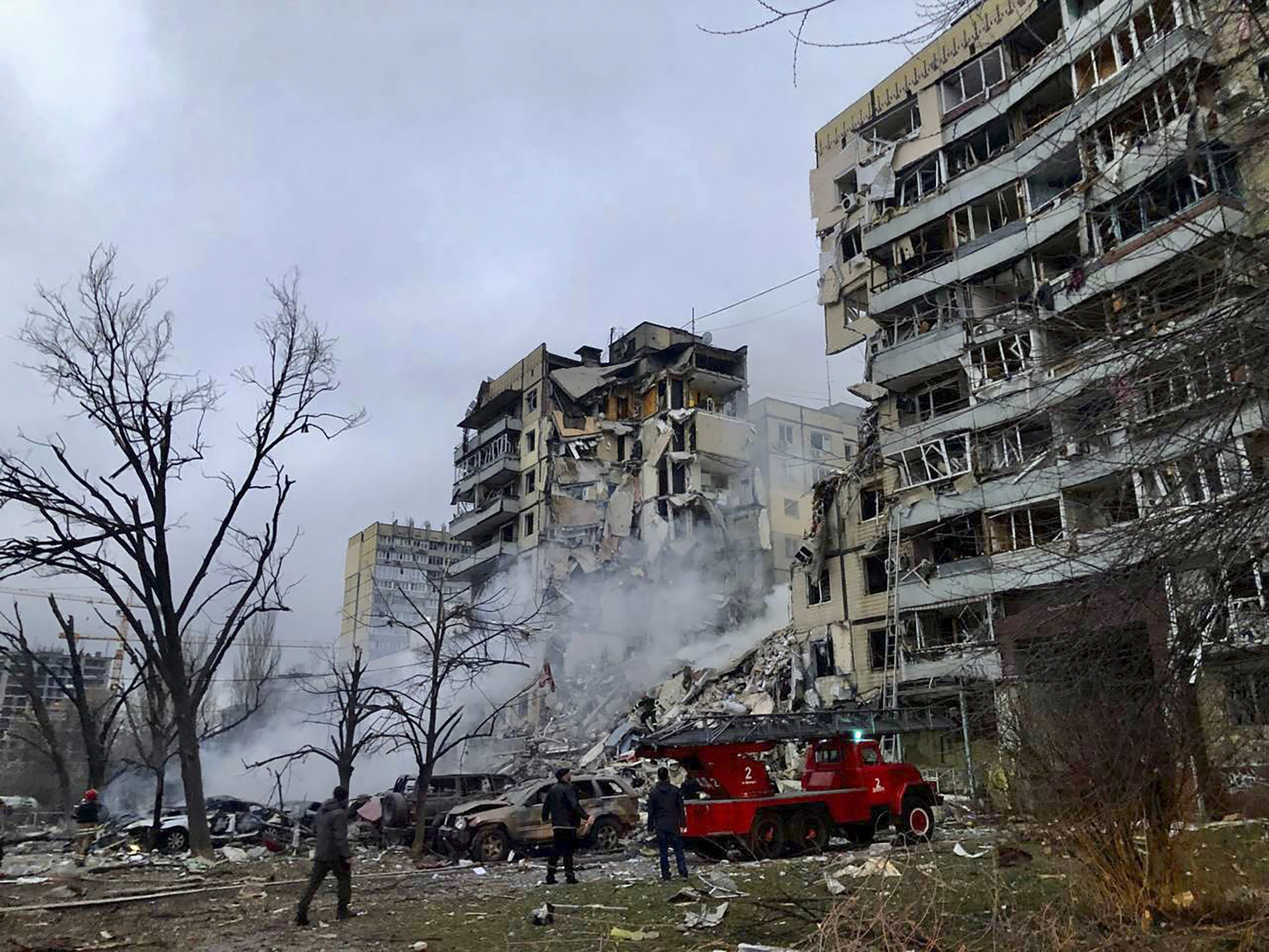 In this photo released by the Ukrainian Presidential Press Office, smoke rises after a Russian rocket hit a multistory building leaving many people under debris in Dnipro, Ukraine, Saturday, Jan. 14, 2023. (Dnipro Regional Administration via AP)