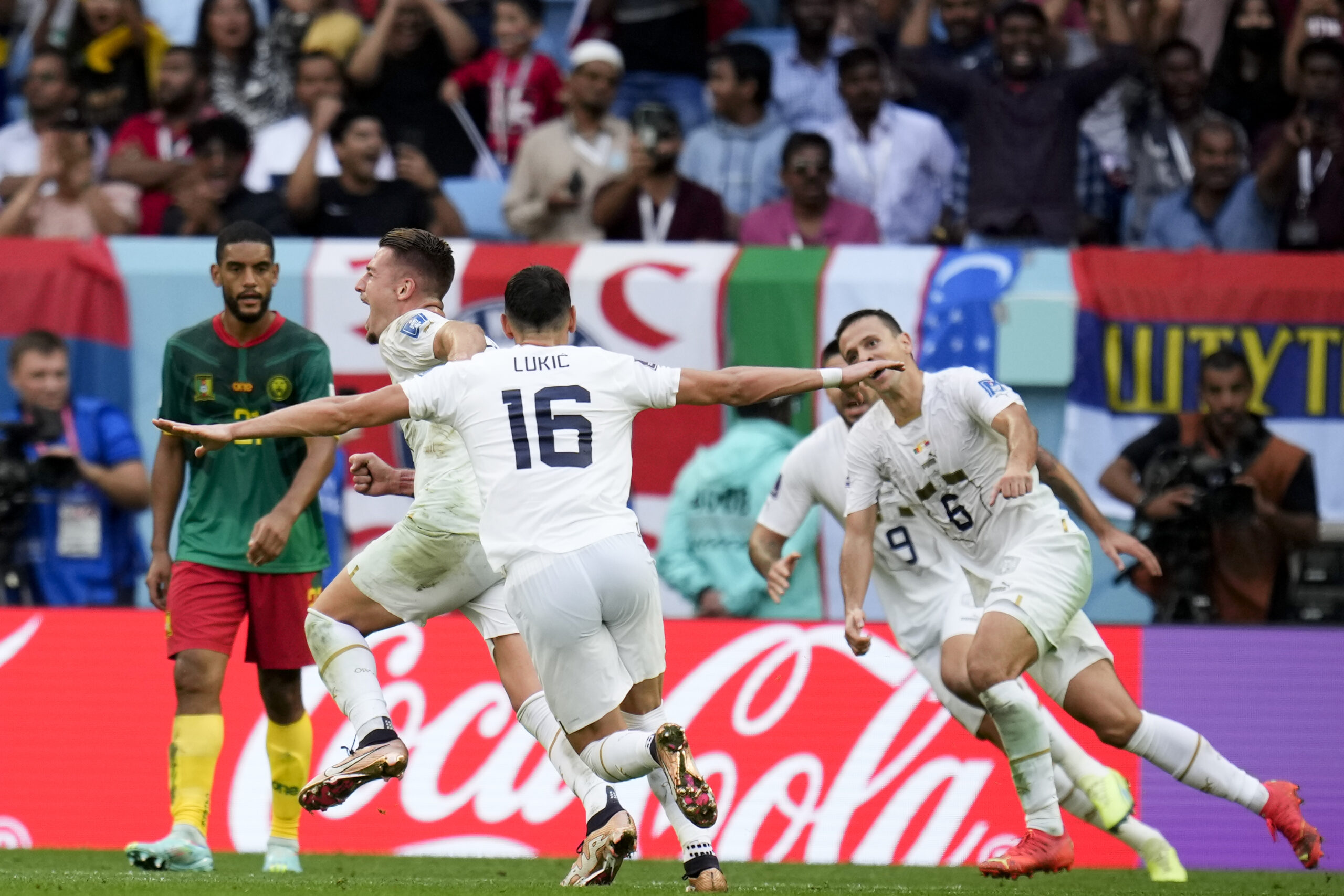 Serbia's Sergej Milinkovic-Savic, left, celebrates scoring his side's second goal during the World Cup group G soccer match between Cameroon and Serbia, at the Al Janoub Stadium in Al Wakrah, Qatar, Monday, Nov. 28, 2022. (AP Photo/Manu Fernandez)