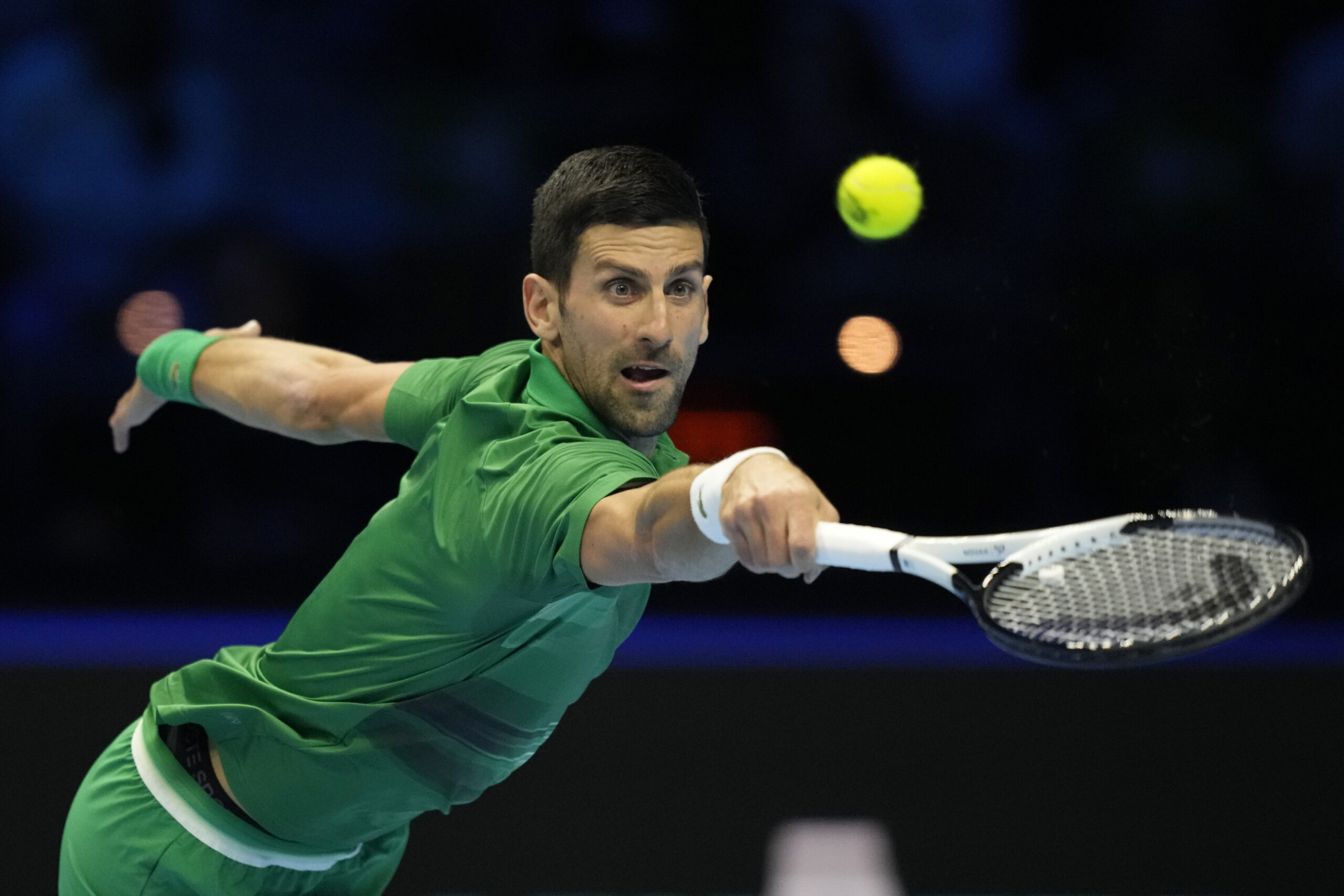 Serbia's Novak Djokovic returns the ball to Greece's Stefanos Tsitsipas during their singles tennis match of the ATP World Tour Finals, at the Pala Alpitour in Turin, Italy, Monday, Nov. 14, 2022. (AP Photo/Antonio Calanni)