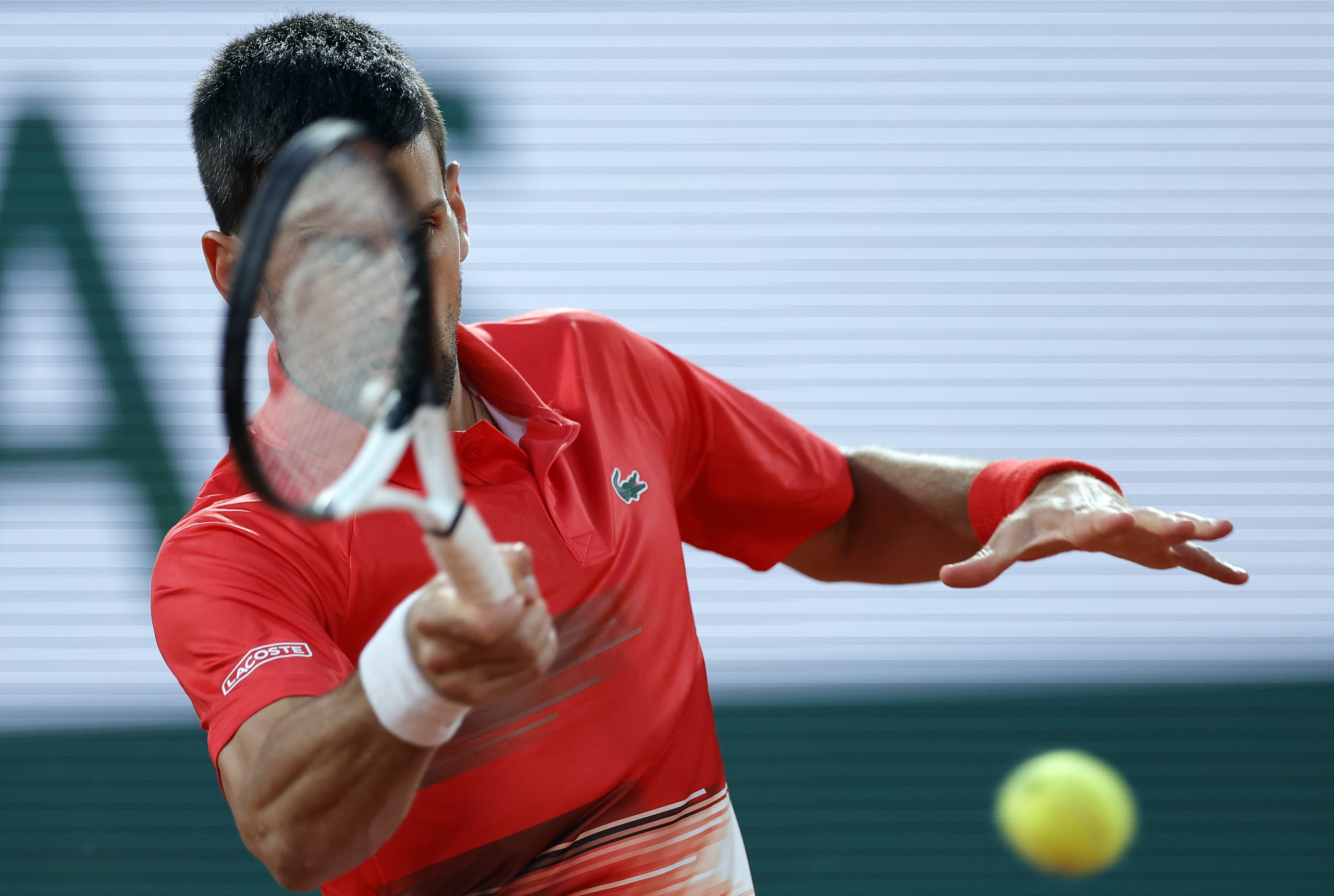 epa09970187 Novak Djokovic of Serbia plays Yoshihito Nishioka of Japan in their men?s first round match during the French Open tennis tournament at Roland ?Garros in Paris, France, 23 May 2022.  EPA-EFE/YOAN VALAT
