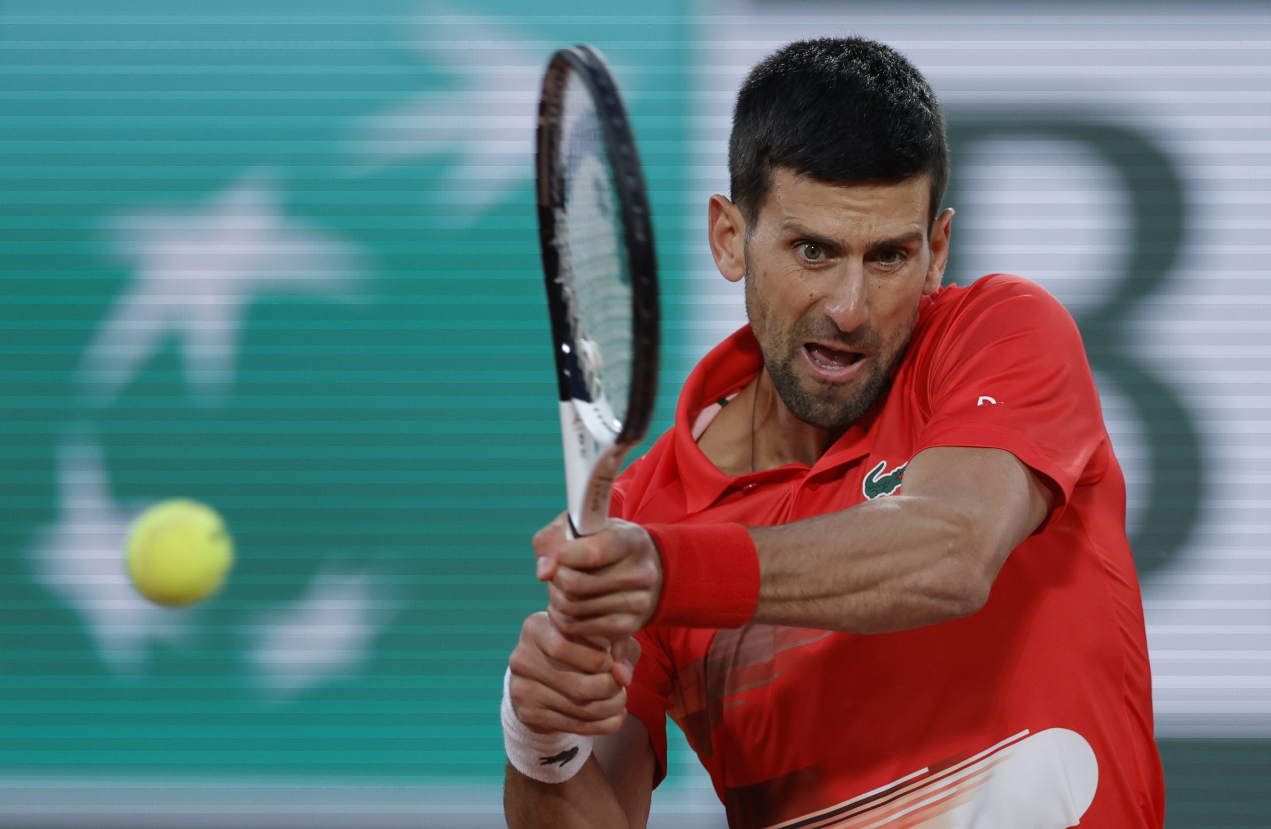 epa09970177 Novak Djokovic of Serbia plays Yoshihito Nishioka of Japan in their men?s first round match during the French Open tennis tournament at Roland ?Garros in Paris, France, 23 May 2022.  EPA-EFE/YOAN VALAT