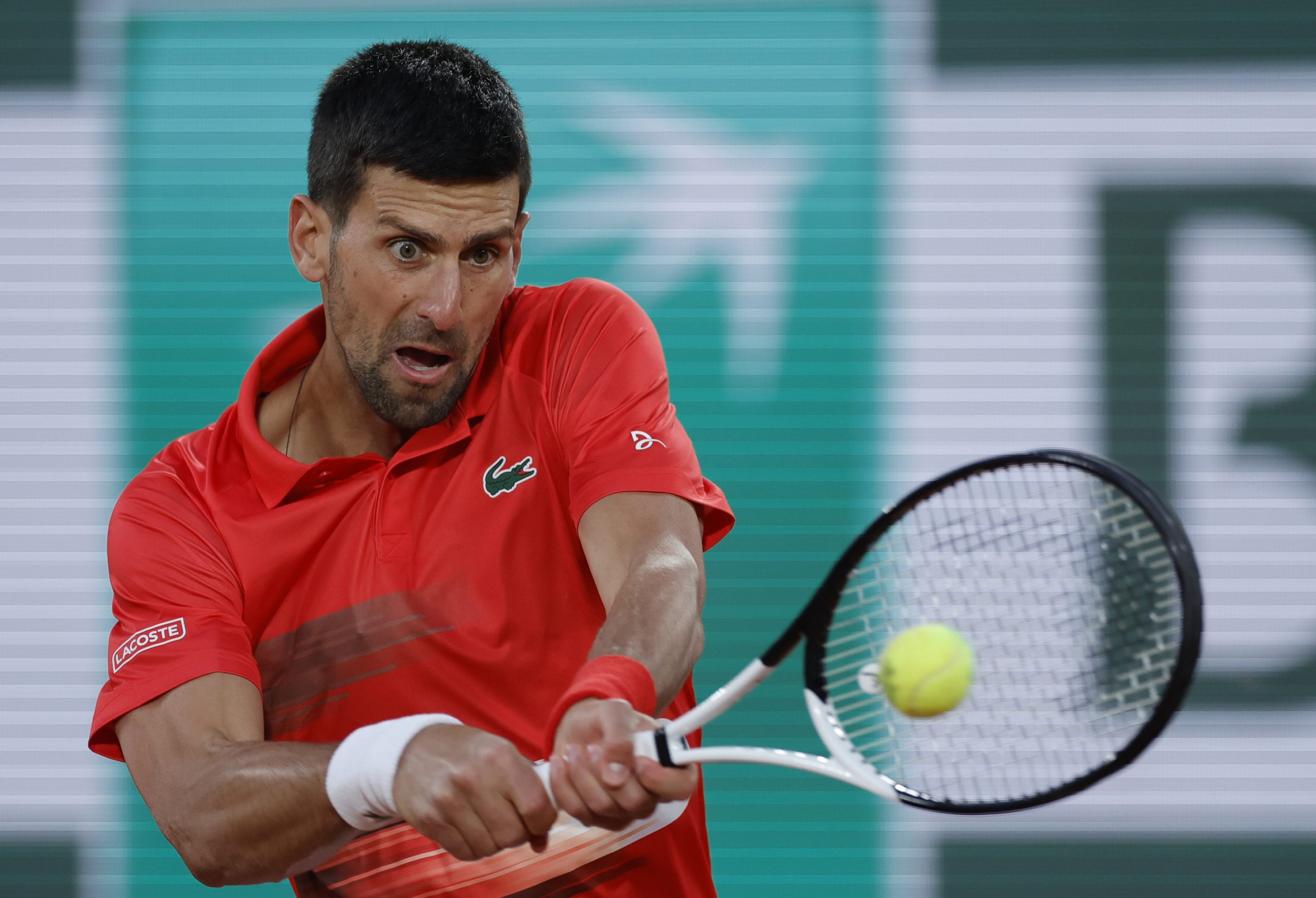 epa09970178 Novak Djokovic of Serbia plays Yoshihito Nishioka of Japan in their men?s first round match during the French Open tennis tournament at Roland ?Garros in Paris, France, 23 May 2022.  EPA-EFE/YOAN VALAT