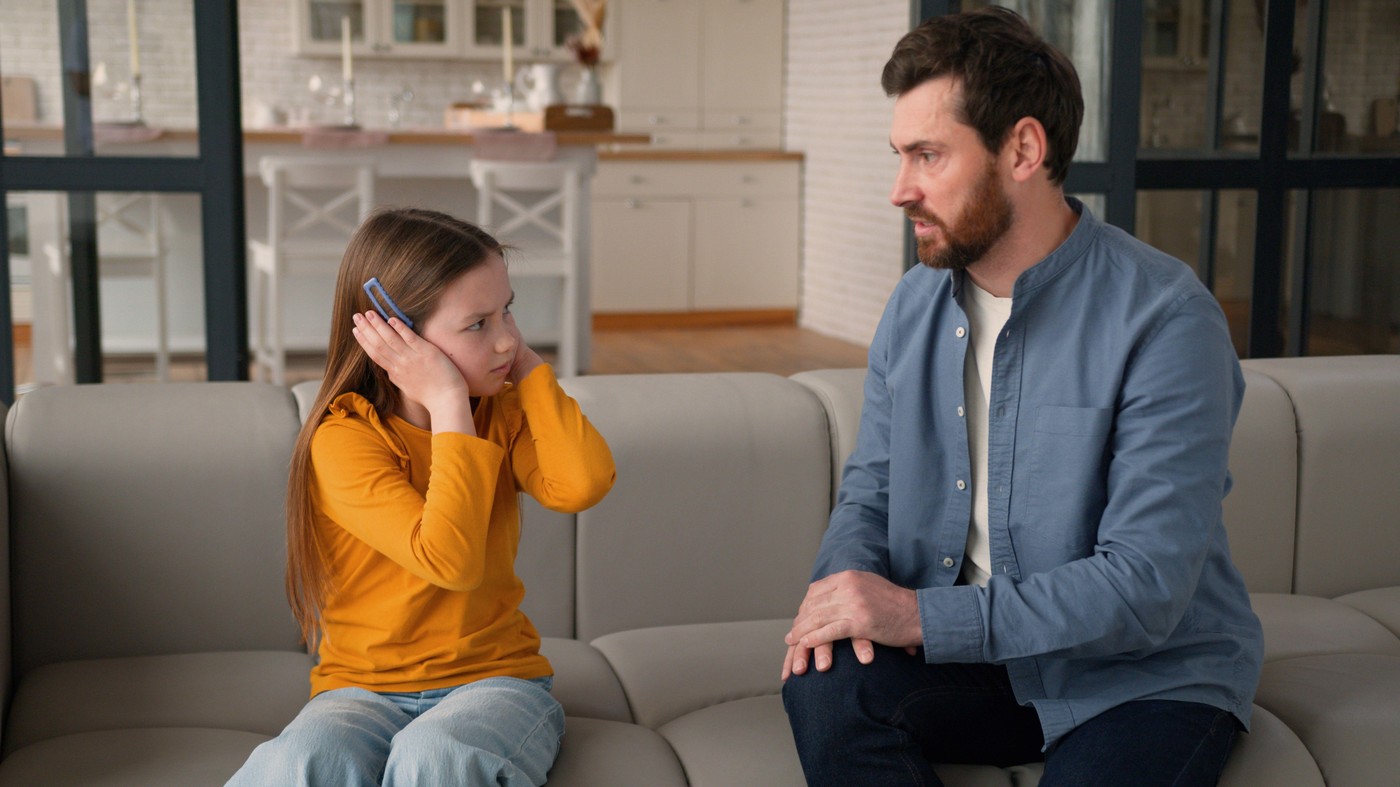 Furious Caucasian man father male screaming at sad afraid child girl punishing for bad behavior argument daughter little kid trouble irritated parent