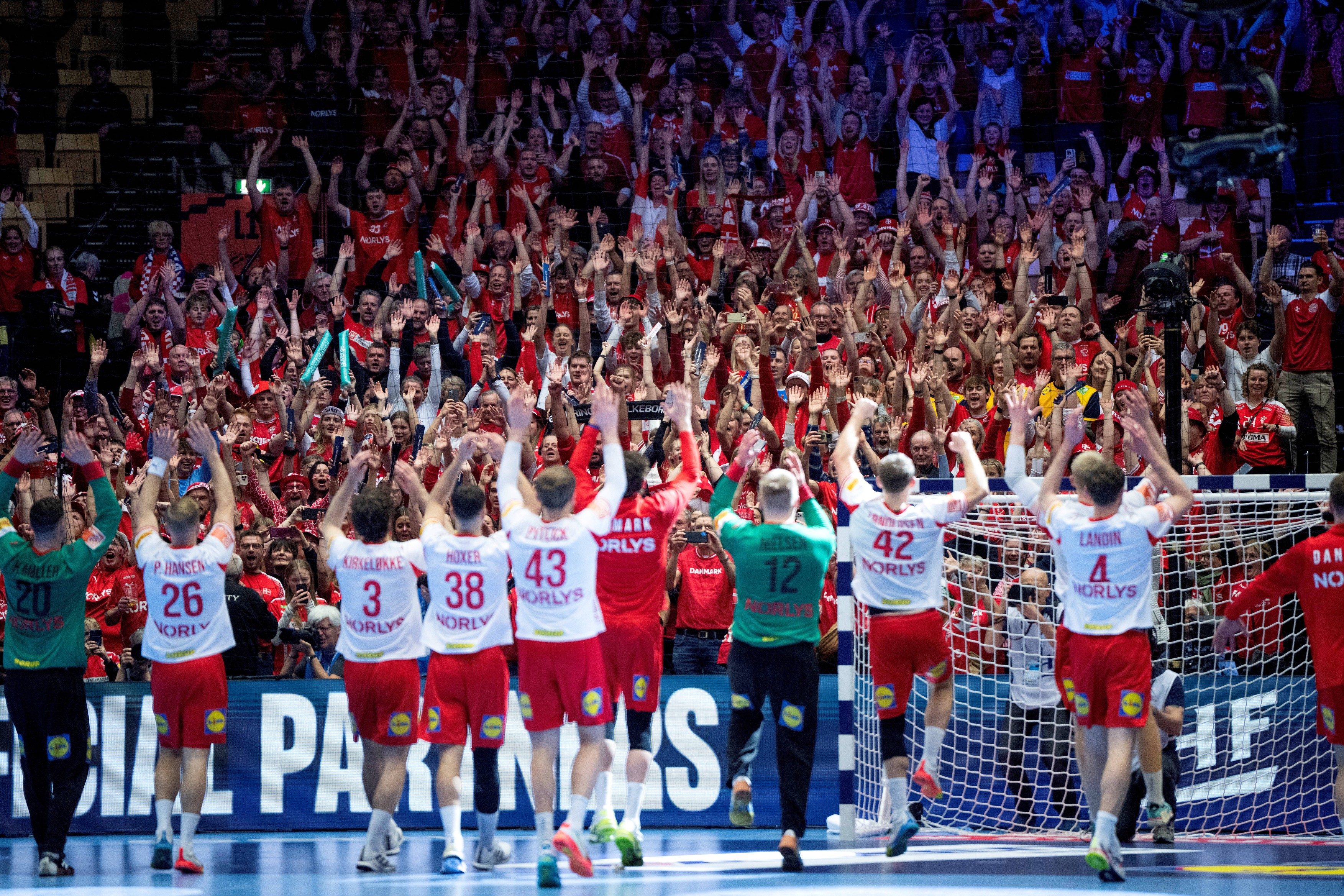 Denmark's players celebrate the victory with the fans at the end of the EHF Euro 2026 semi-finals handball match against Iceland in Herning, Denmark, on January 30, 2026.