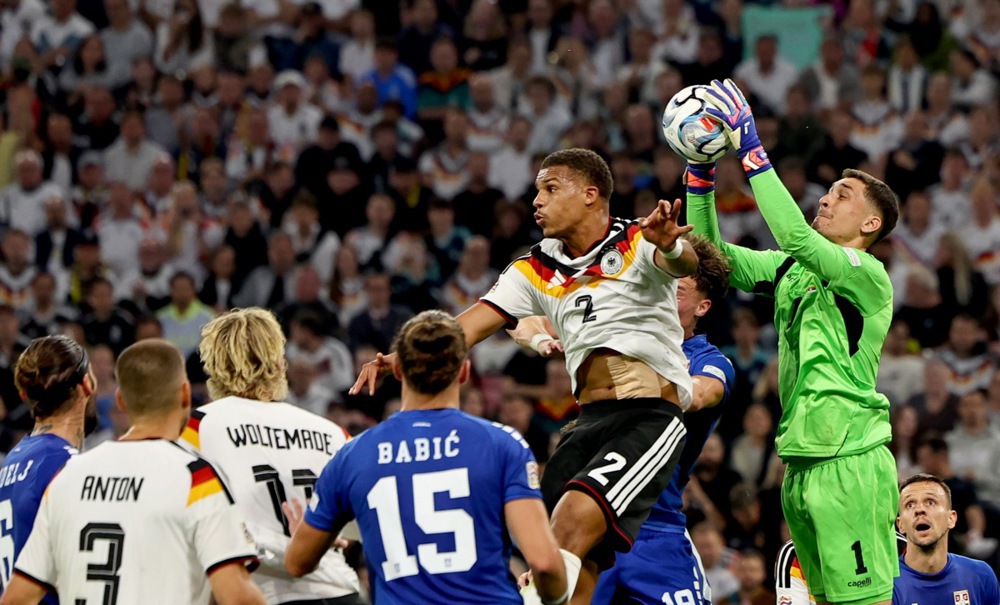 epa13275739 Malick Thiaw of Germany in action against goalkeeper Djordje Petrovic of Serbia during the UEFA Nations League match between Germany and Serbia in Munich, Germany, 01 October 2026.  EPA/ANNA SZILAGYI