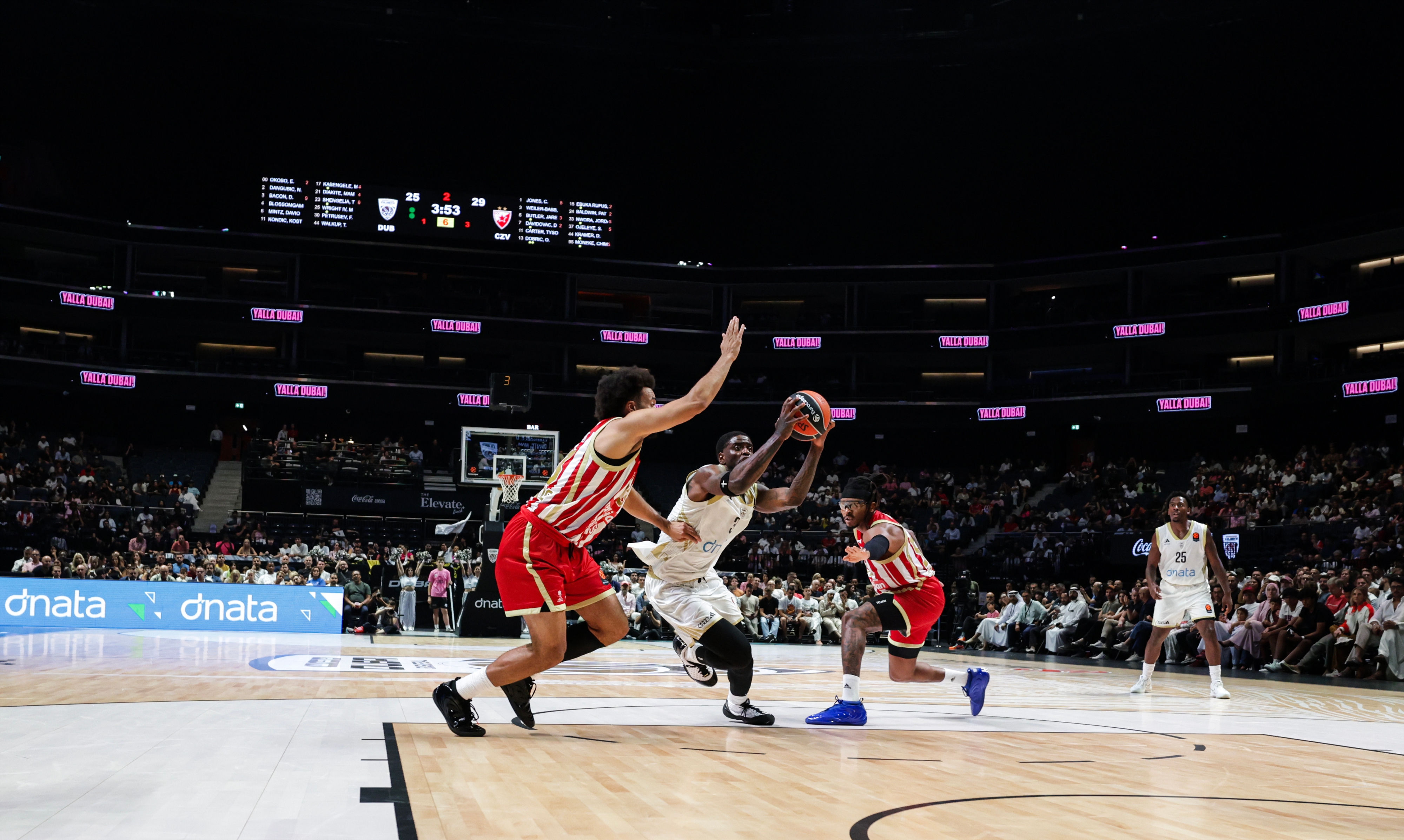 Dubai Basketball's Dwayne Bacon (C) and Crvena Zvezda's Jordan Nwora (L) in action