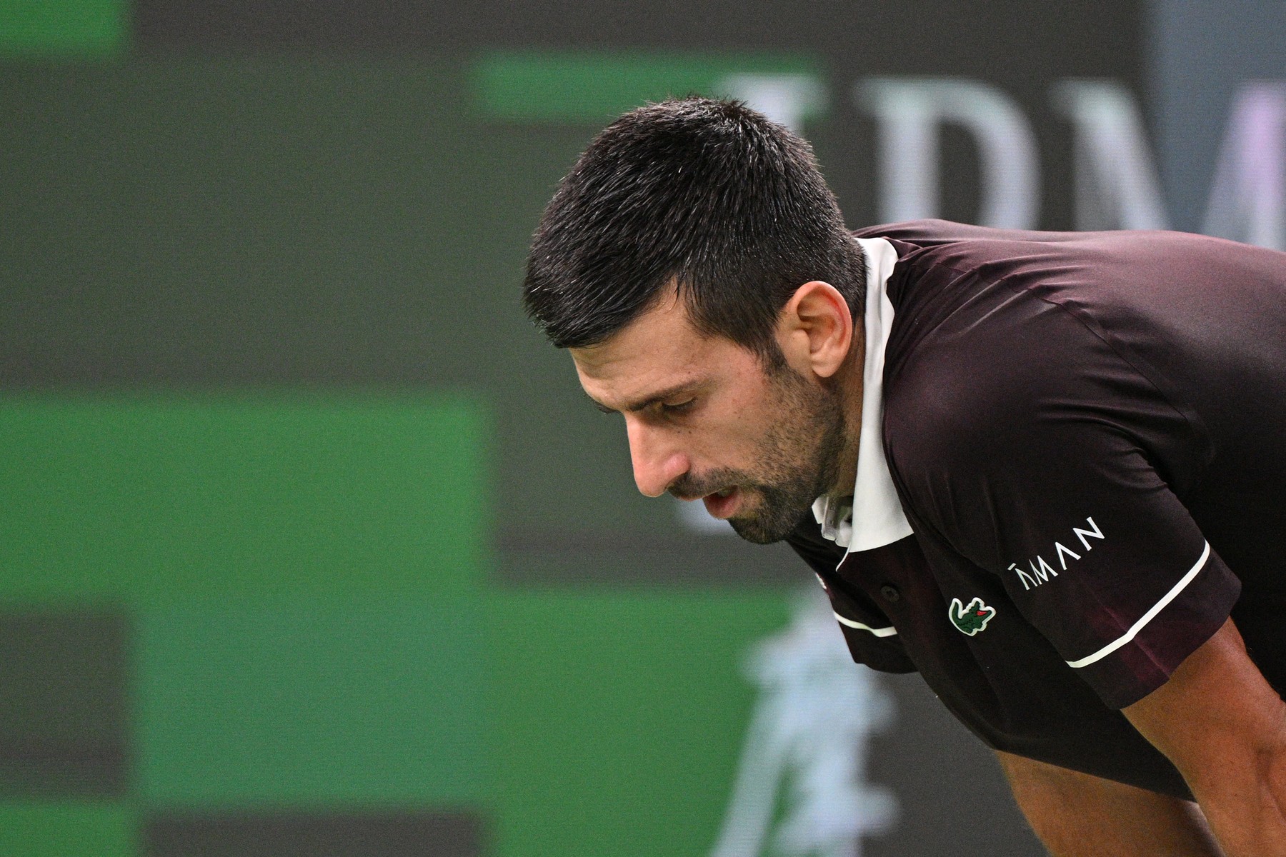 Serbia's Novak Djokovic rests between games against Poland's Hubert Hu