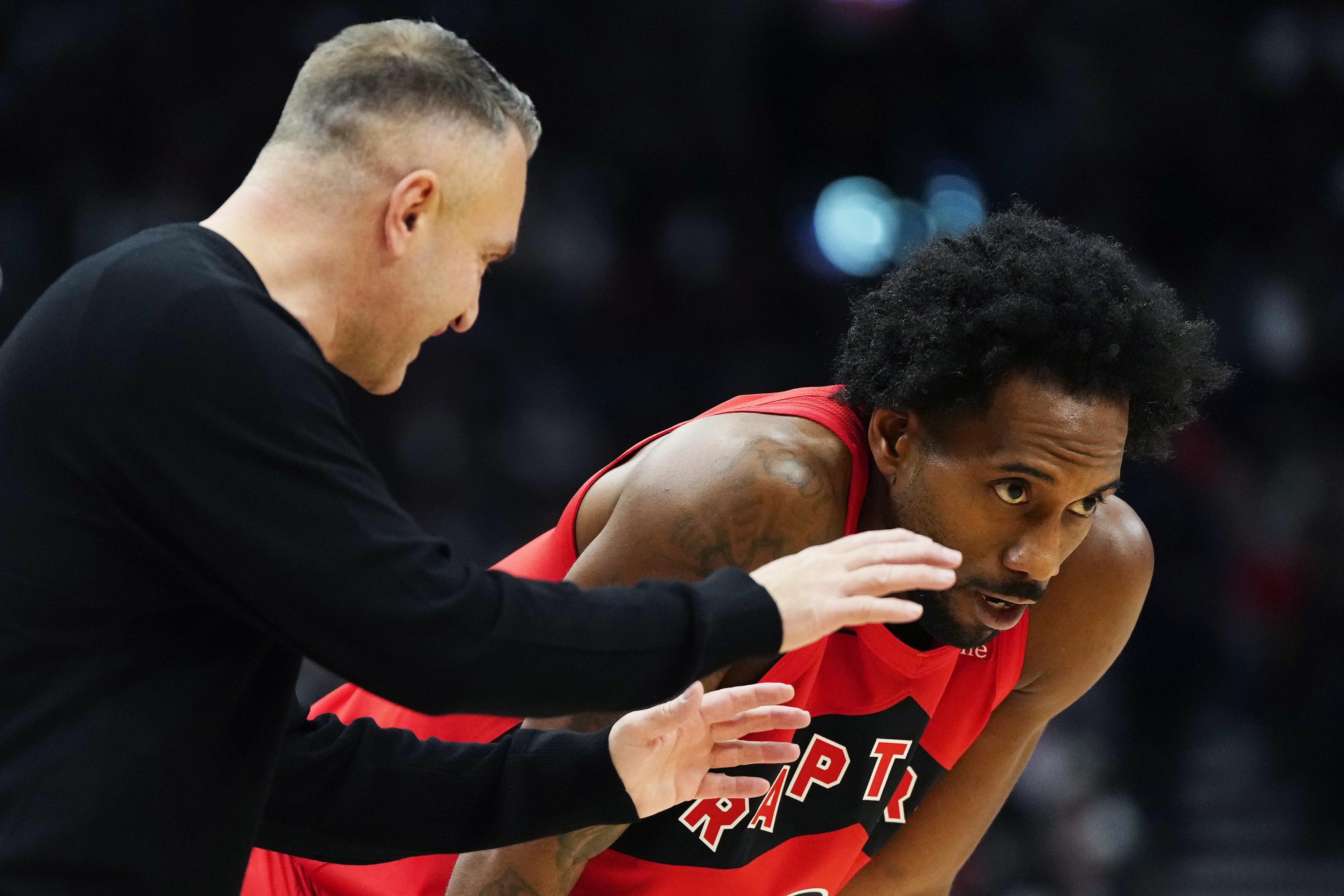 Toronto Raptors head coach Darko Rajakovic speaks with Kawhi Leonard (2)