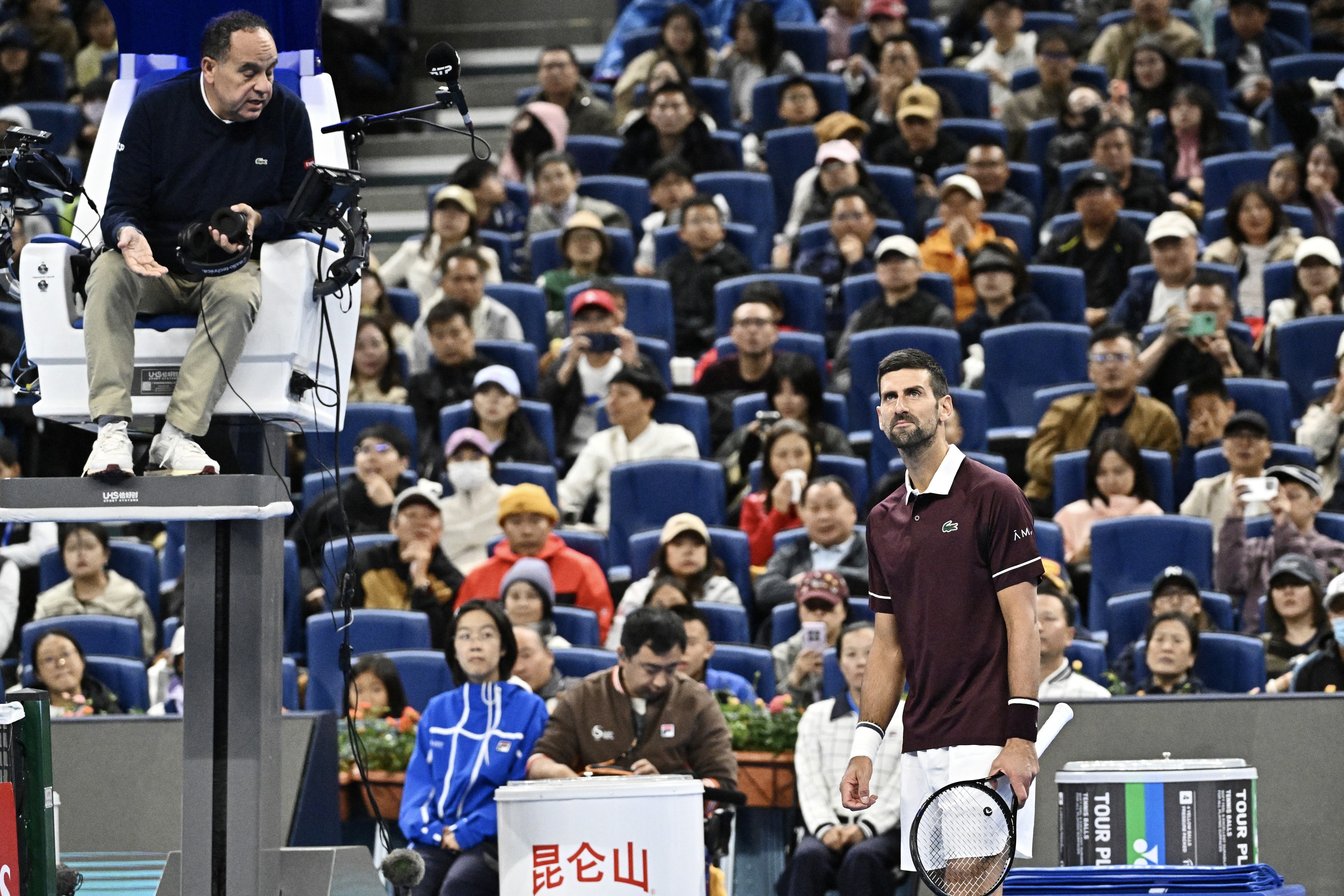Serbia's Novak Djokovic (R) argues with the referee during his men's singles