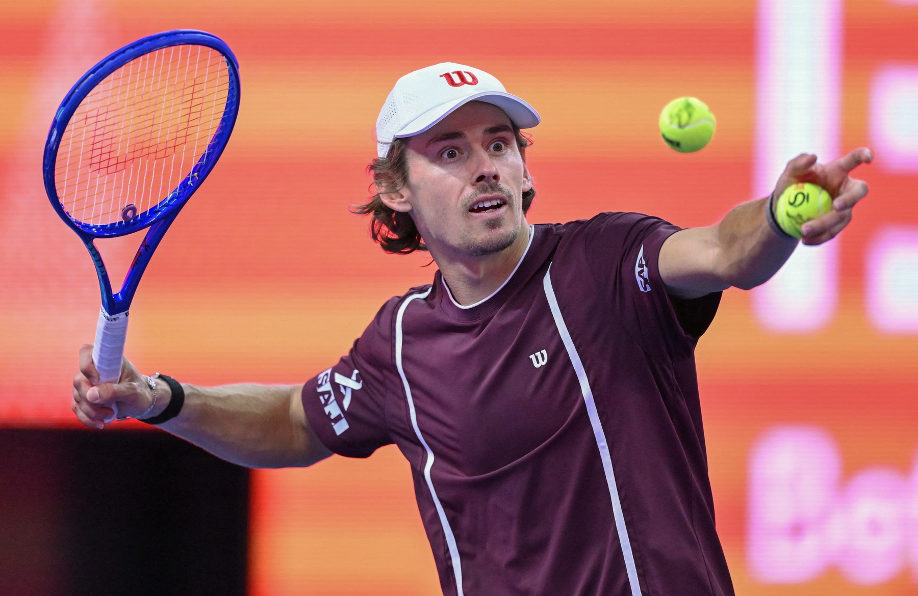 Australia’s Alex de Minaur hits a ball towards spectators after winning against
