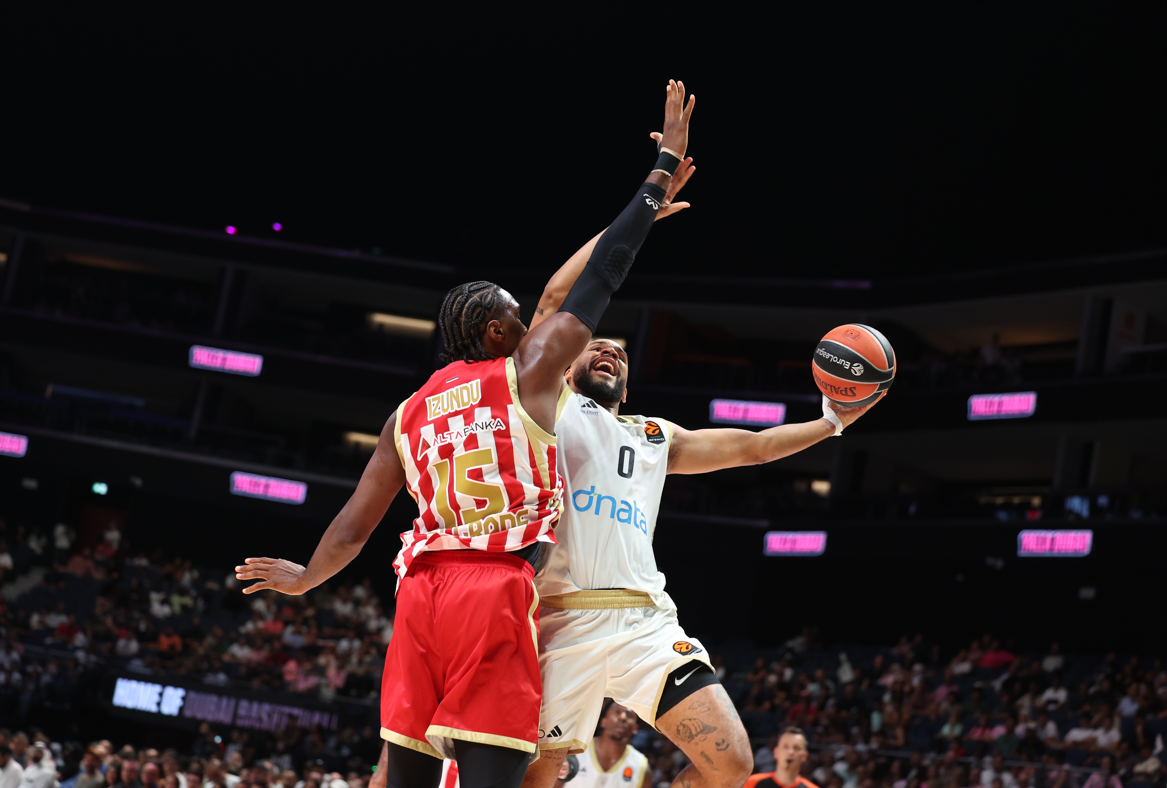 Dubai Basketball's Elie Okobo (R) and Crvena Zvezda's Ebuka Izundu in action