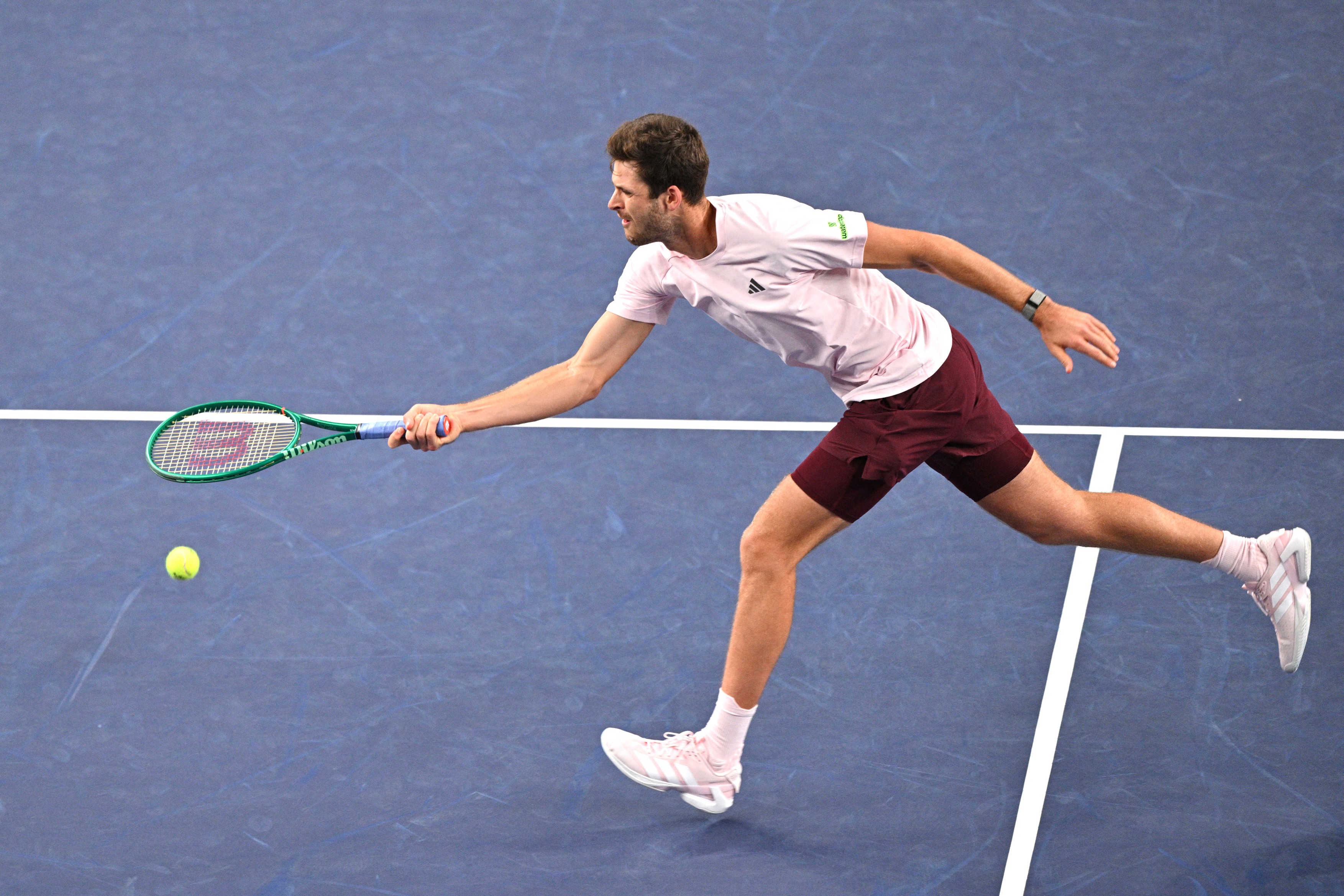 Poland's Hubert Hurkacz hits a return to Serbia's Novak Djokovic