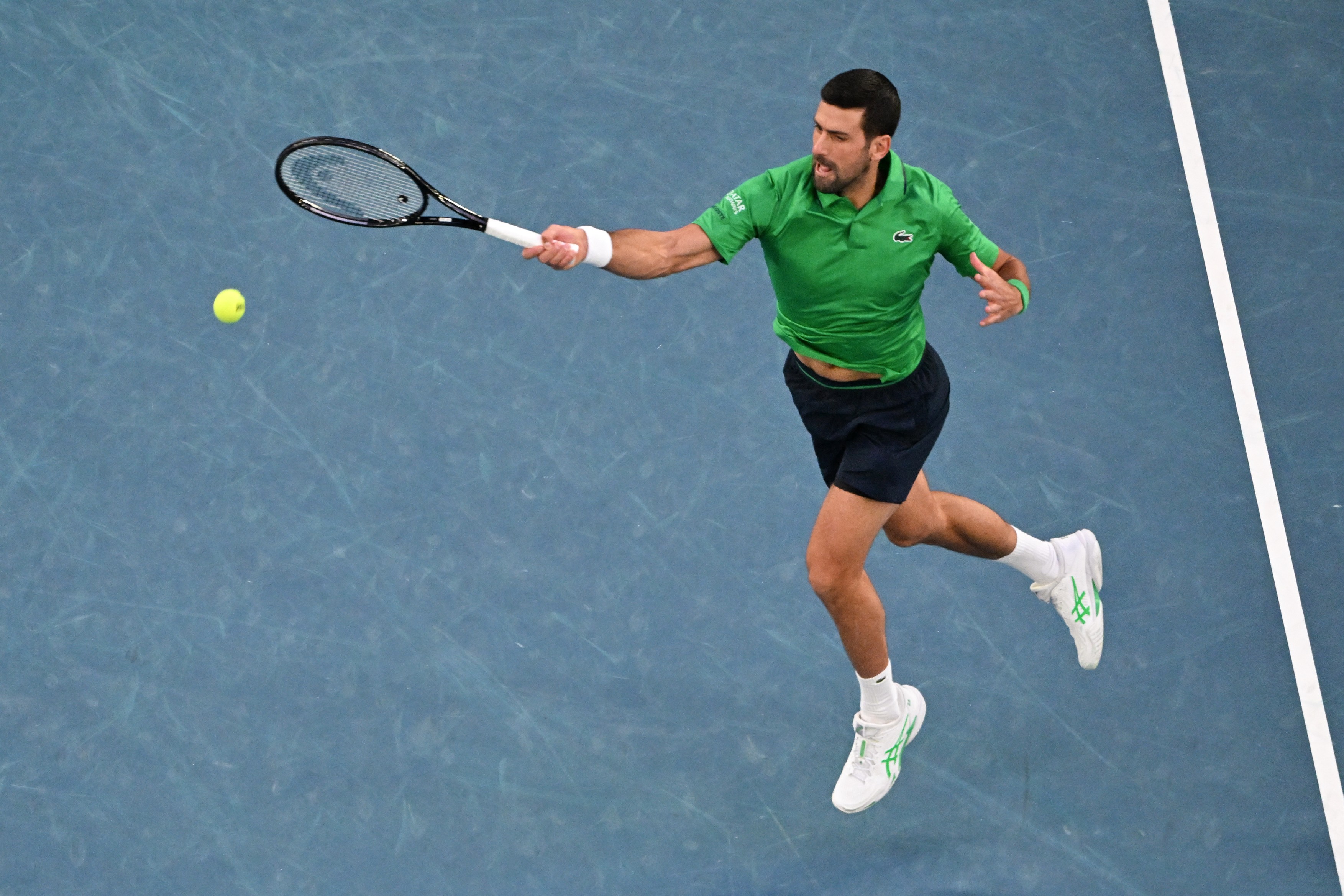 Serbia's Novak Djokovic hits a return against Spain's Carlos Alcaraz