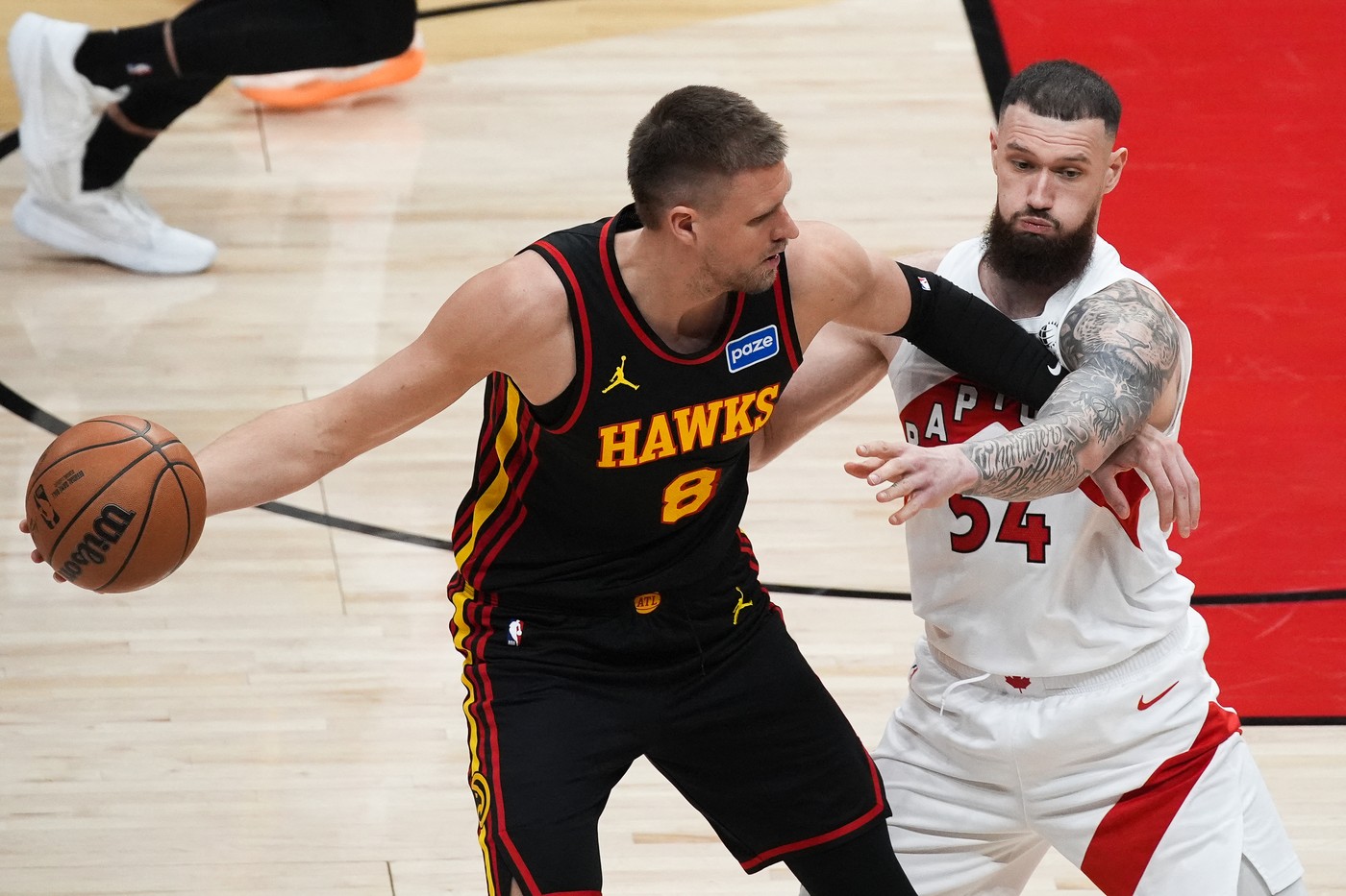 Sandro Mamukelashvili (54) of Toronto Raptors in action against Kristaps Porzingis (8)