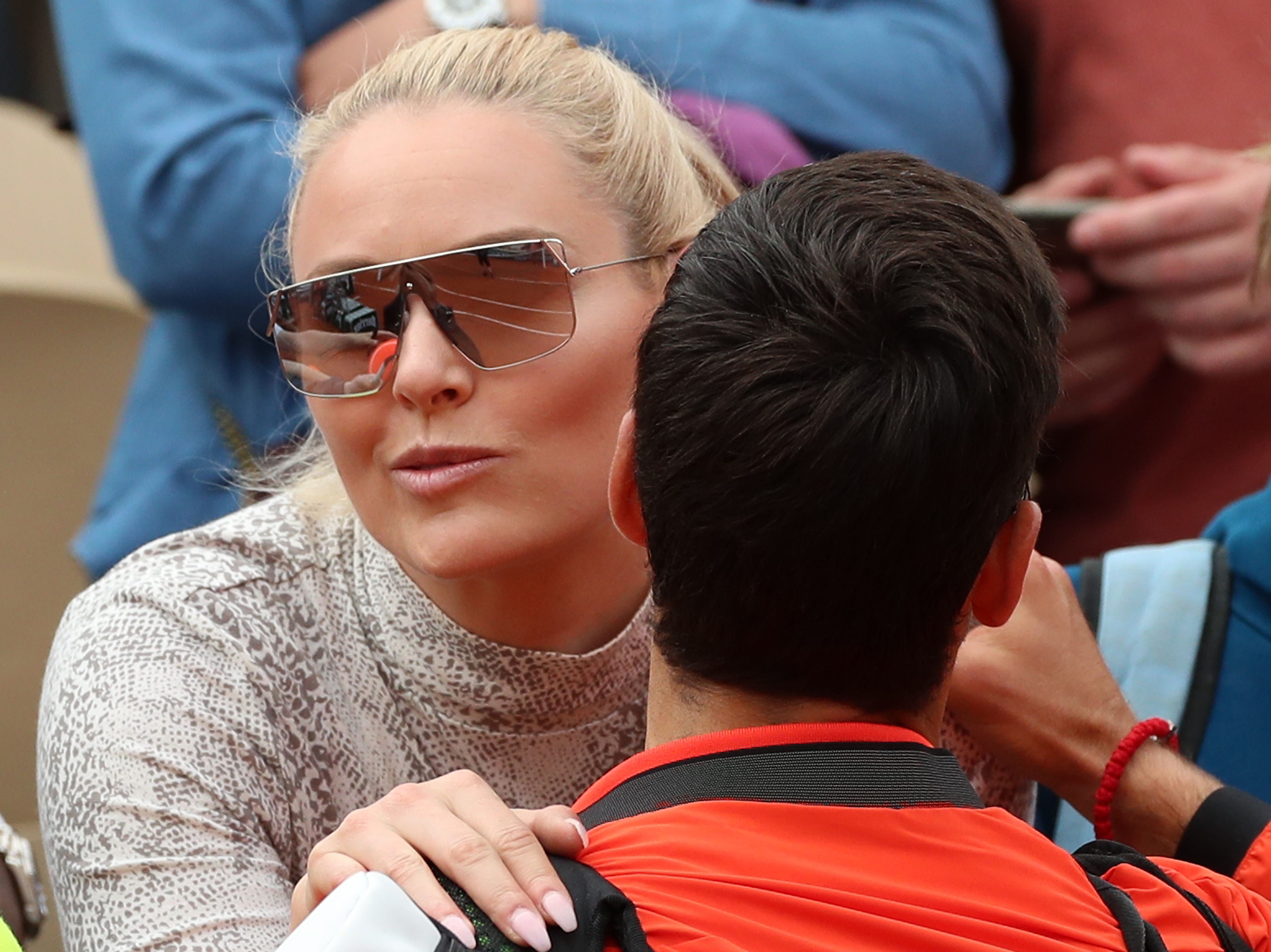 Former US Alpine Skier Lindsey Vonn (L) reacts with Novak Djokovic of Serbia after he won against Henri Laaksonen of Switzerland their men’s second round match during the French Open tennis tournament at Roland Garros in Paris