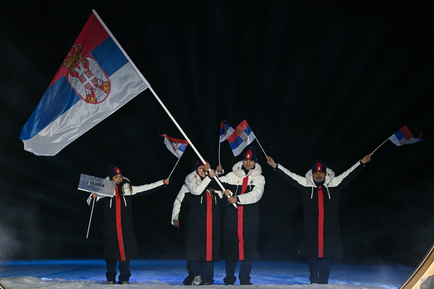 Serbia's flag bearers Anja Ilic (2L) and Milos Milosavljevic (2R) parade