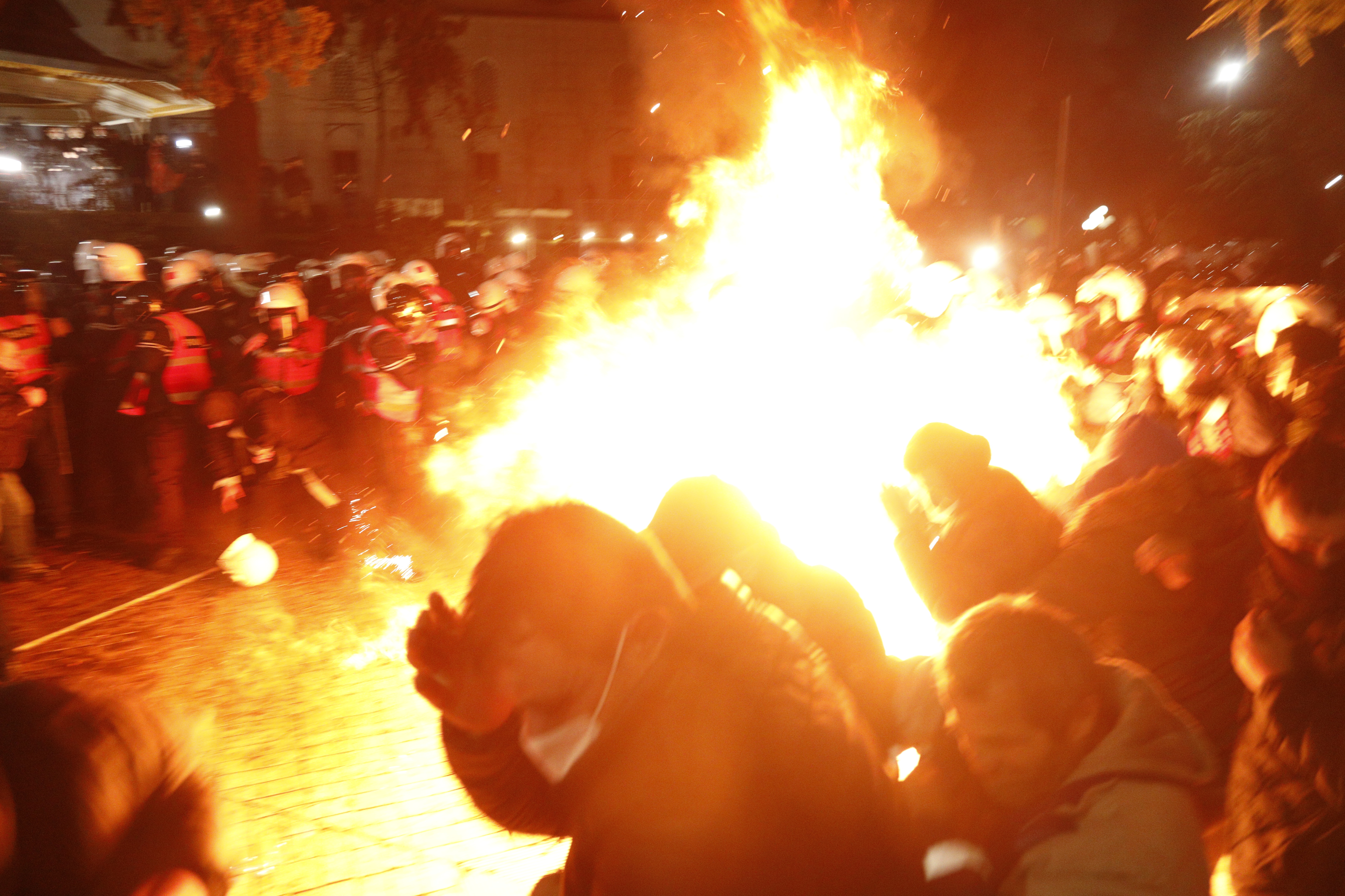 epa12725094 An opposition supporter throws a Molotov cocktail at police officers dur