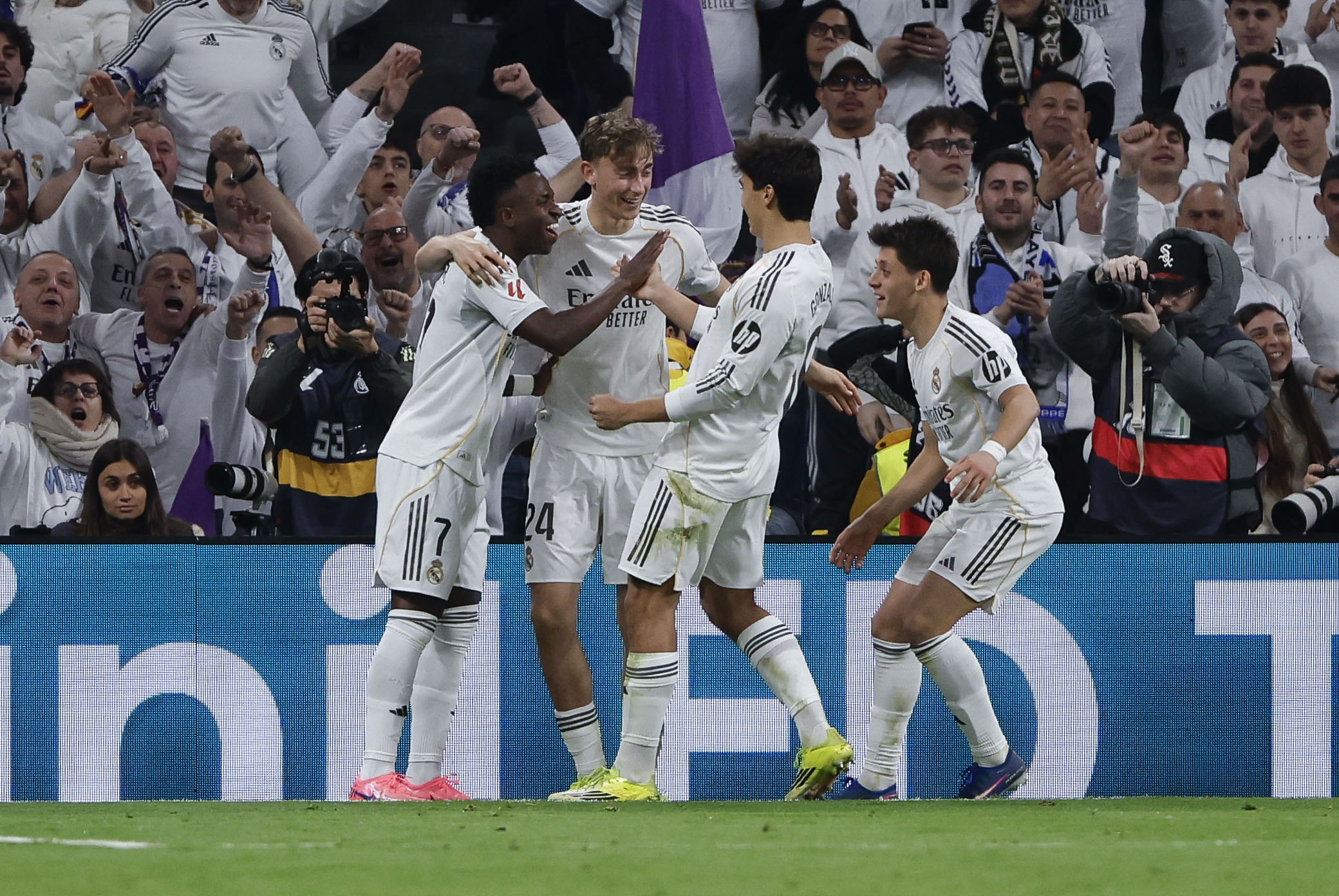 Real Madrid's Vinicius jr (L) celebrates with his teammates after scoring the 4-1 goal during the Spanish LaLiga soccer match versus Real Sociedad at the Santiago Bernabeu