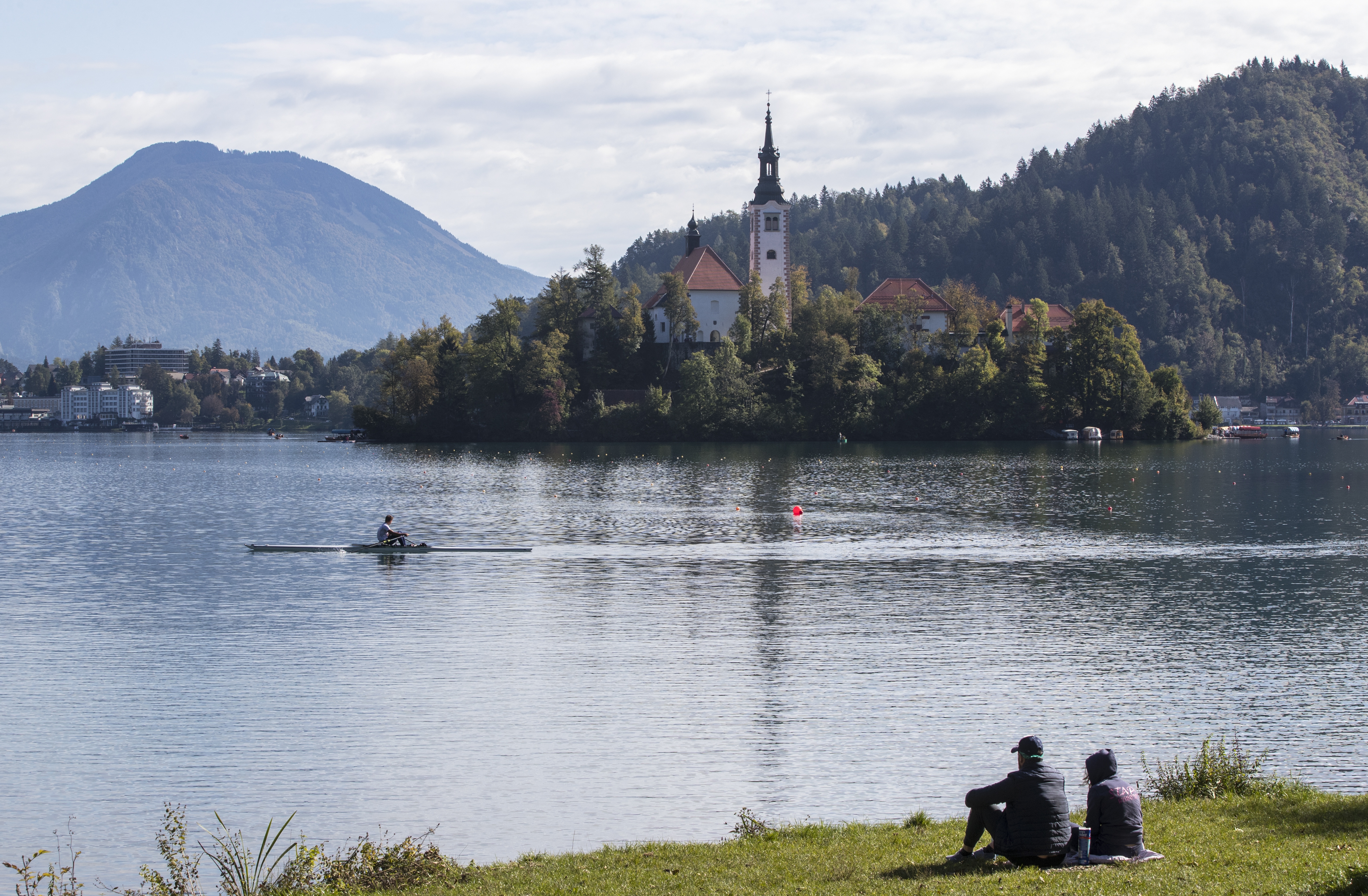 epaselect epa07897584 A view of the Church of the Assumption covered trees with autumn foliage on Bled Island in Lake Bled, Slovenia, 05 October 2019.  EPA/ERDEM SAHIN