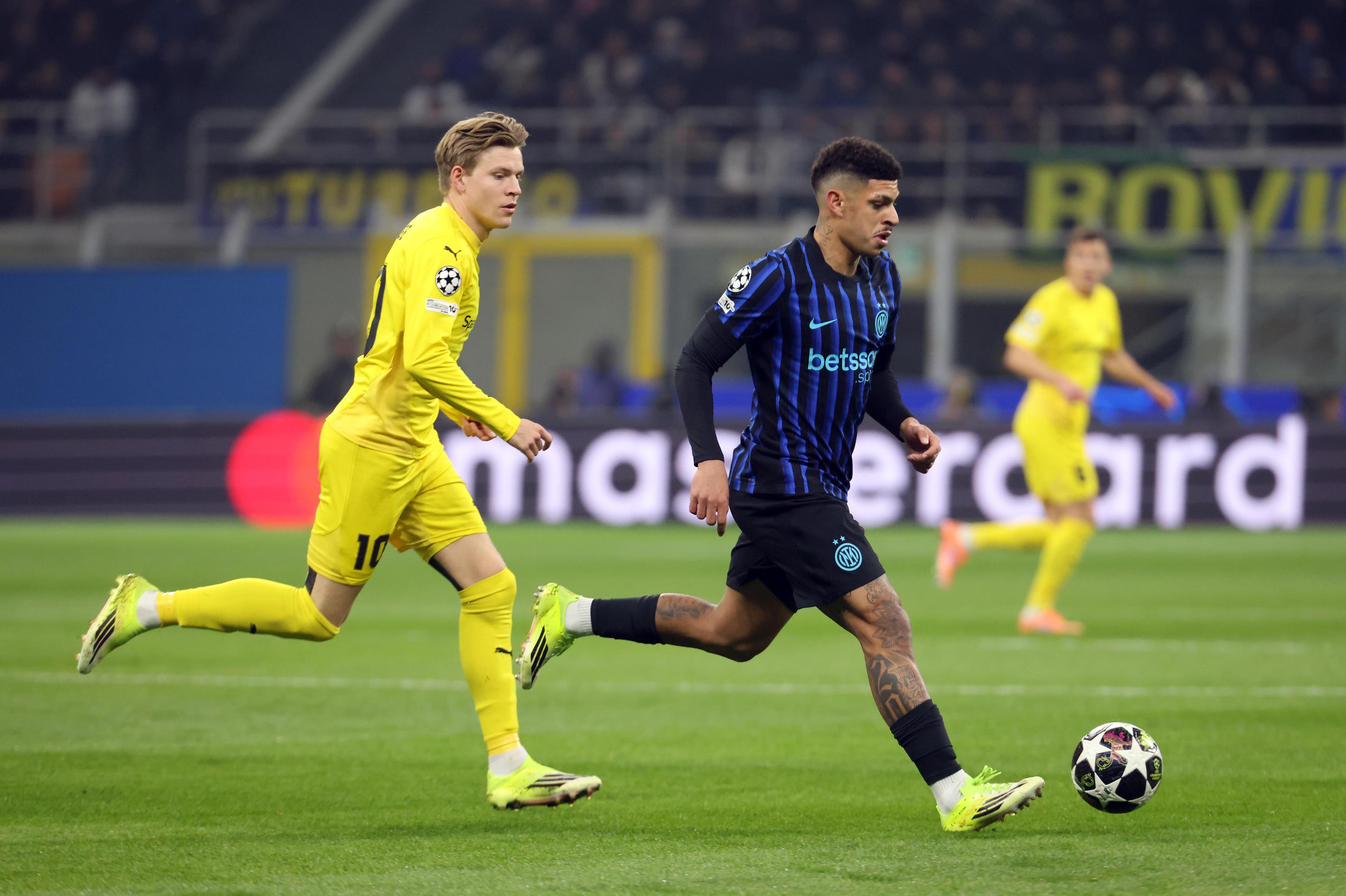Bodo/Glimt's Jens Petter Hauge (L) challenges for the ball with Inter Milan’s Luis Henrique during the UEFA Champions League play-offs 2st leg soccer match