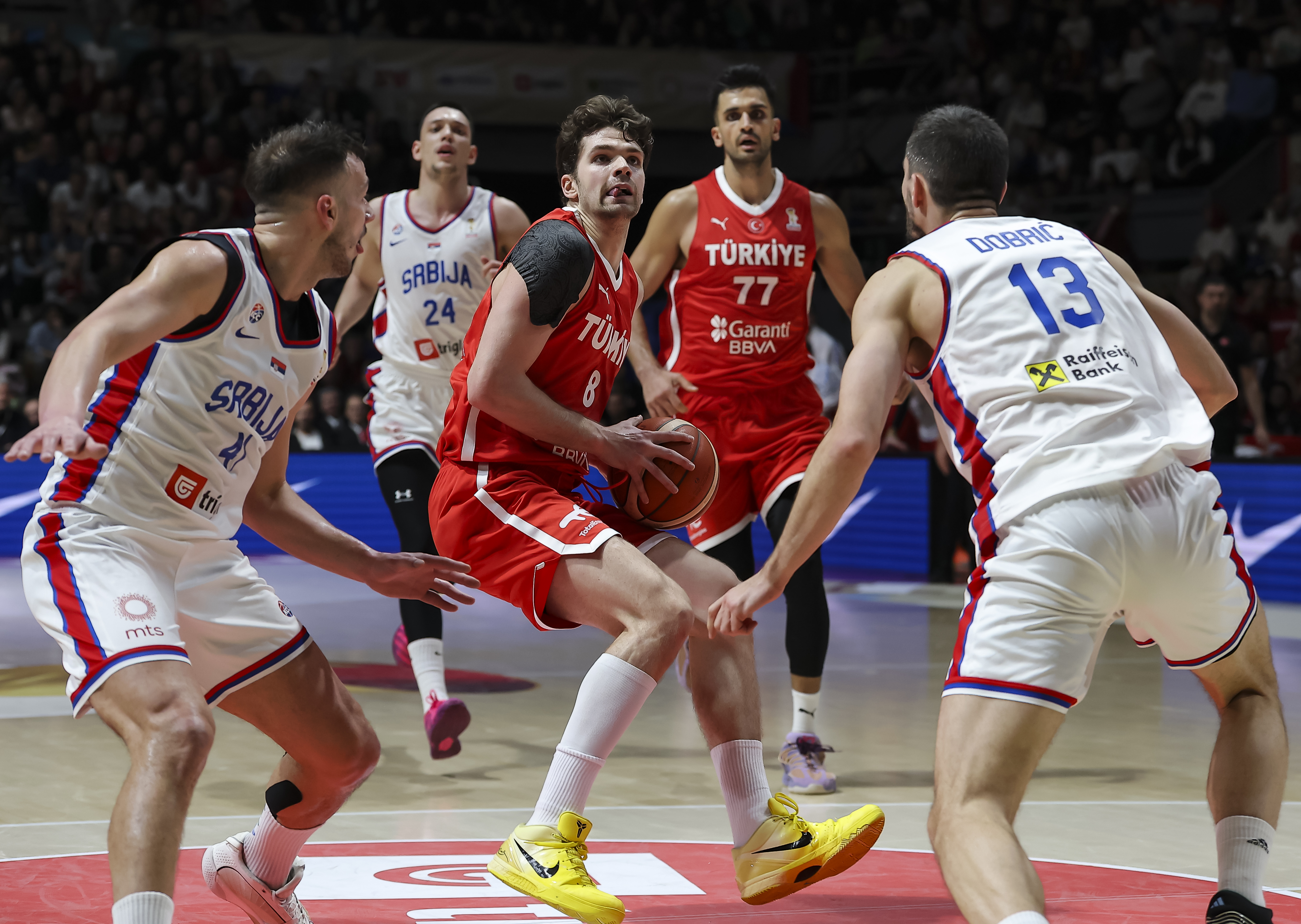Tarik Biberovic (C) of Turkiye in action against Ognjen Dobric (R) and Jovan Novak of Serbia during the FIBA World Cup European qualifiers first round group C