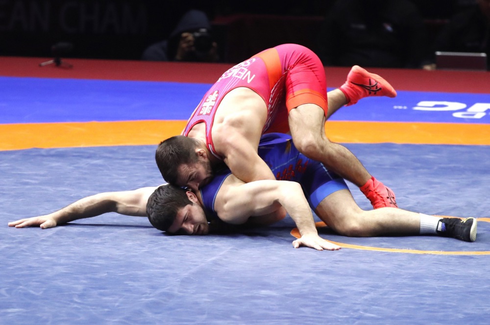 epa10586801  Malkhas Amoyan of Armenia (in blue) in action against Viktor Nemes of Serbia