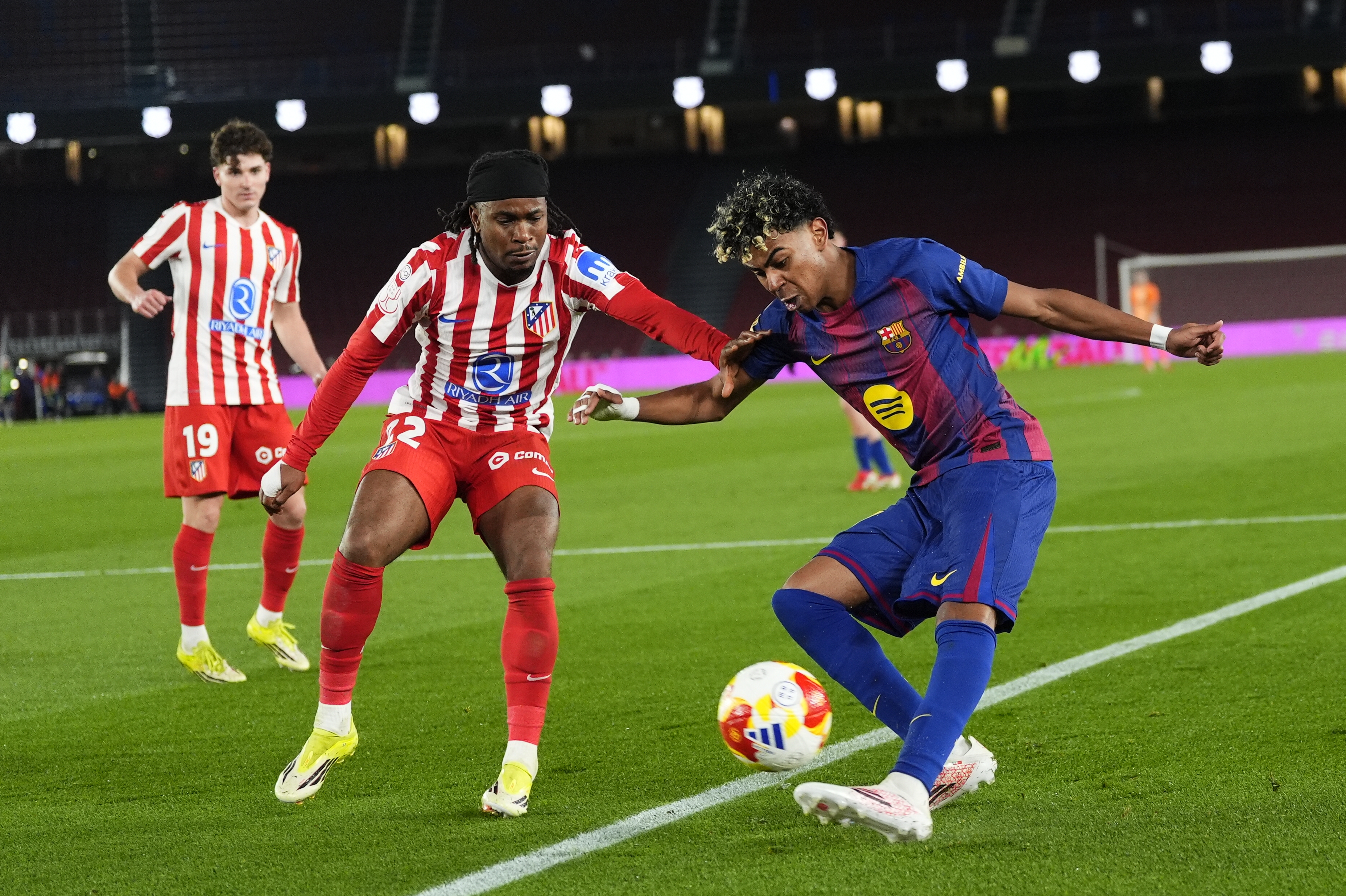 Barcelona's Lamine Yamal in action against Atletico de Madrid's Ademola Lookman (L) during the Spanish King's Cup second leg semifinal