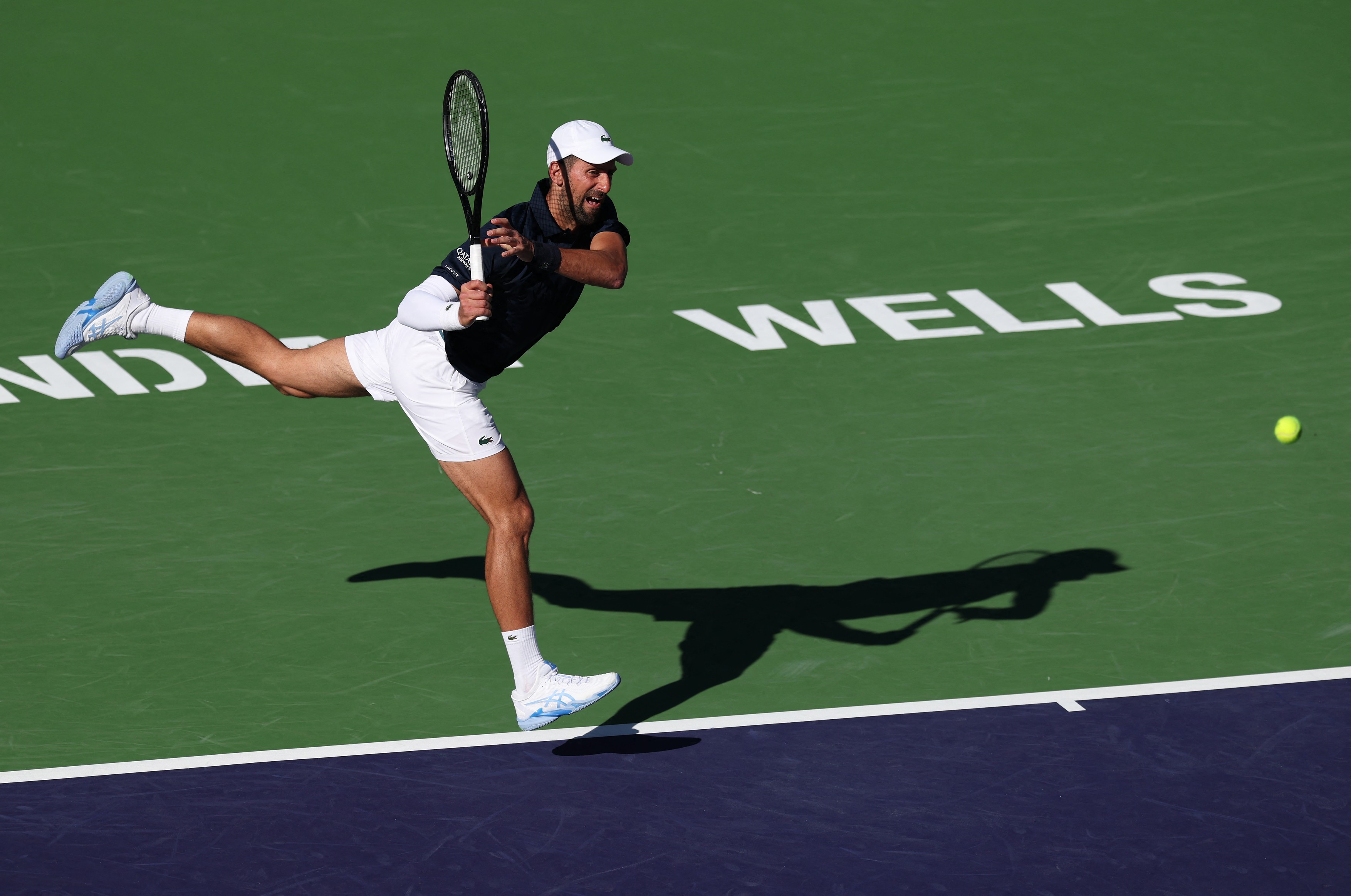 INDIAN WELLS, CALIFORNIA - MARCH 07: Novak Djokovic of Serbia plays a backhand against Kamil Majchrzak of Poland