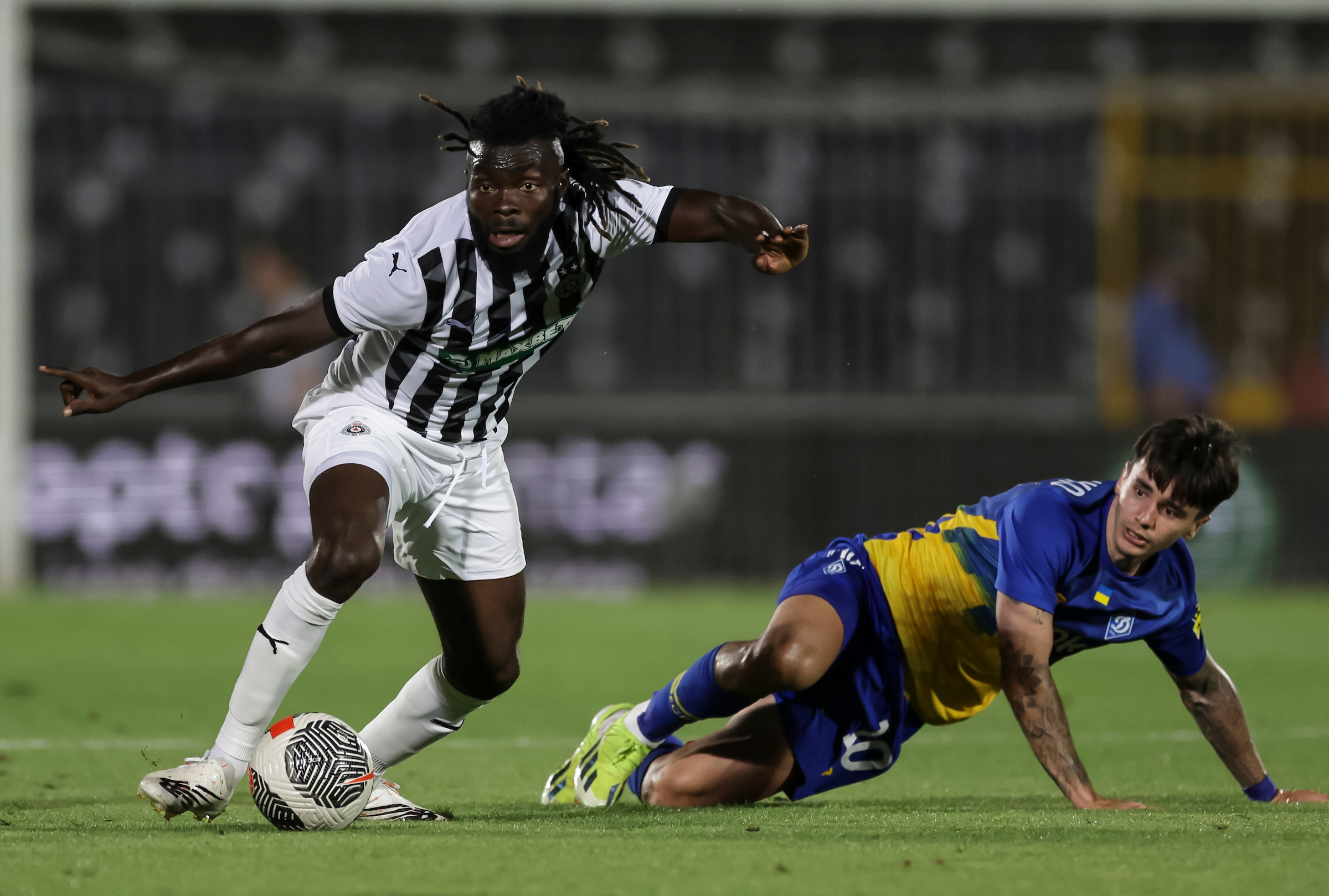 Leonard Owusu (L) of Partizan in action against Mykola Shaparenko (R) of Dynamo Kyiev in action during the UEFA Champions League Second Qualifying Round 2nd leg match at Partizan Stadium on July 31, 2024 in Belgrade, Serbia.