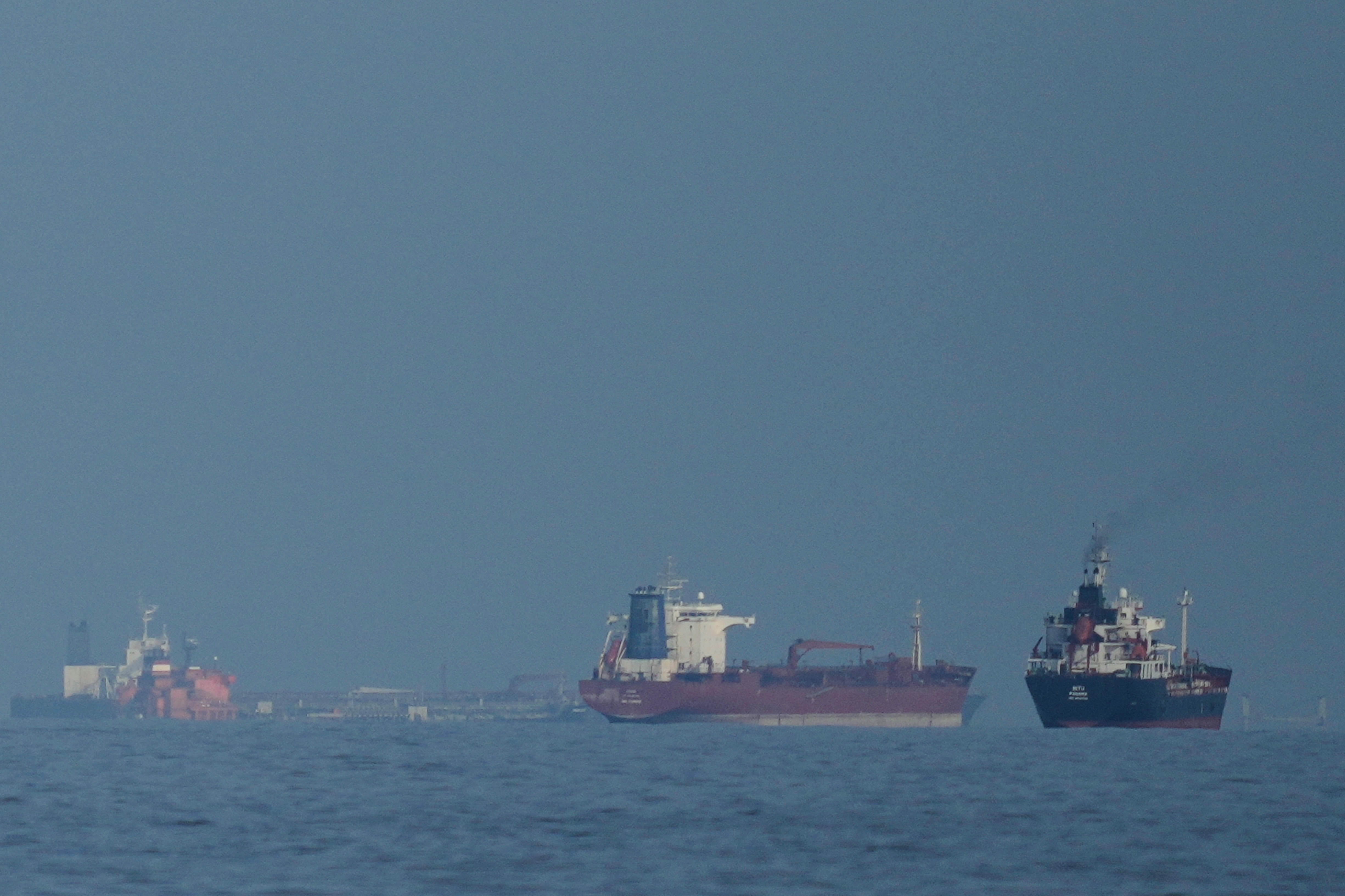 Oil tankers and cargo ships line up in the Strait of Hormuz as seen from Khor Fakkan, United Arab Emirates, Wednesday, March 11, 2026. (AP Photo/Altaf Qadri)