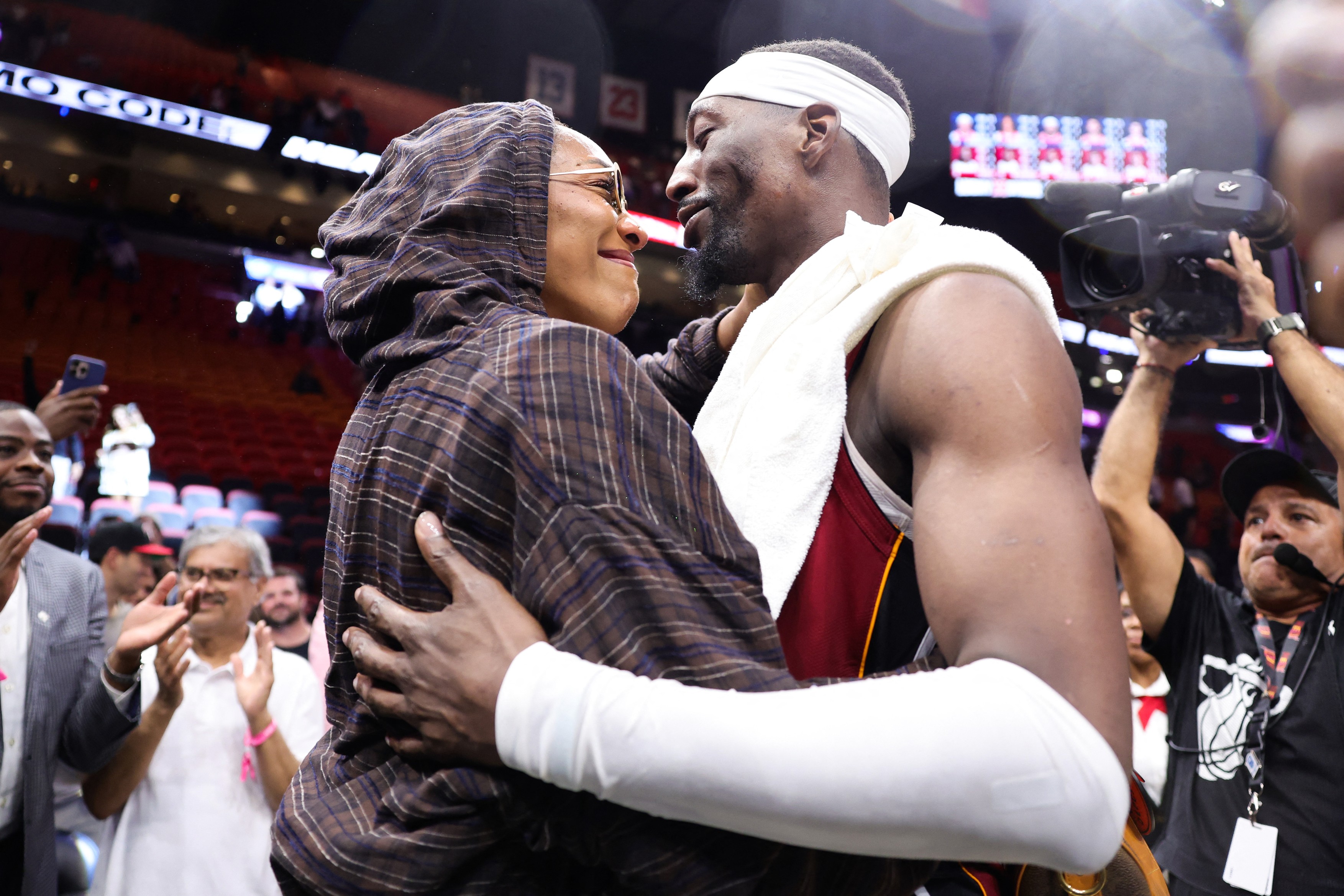 WNBA player A'ja Wilson and Bam Adebayo #13 of the Miami Heat embrace after a 150-129 win over the Washington Wizards at Kaseya Center, Adebayo passed Kobe Bryant for the second most points scored in an NBA game with 83