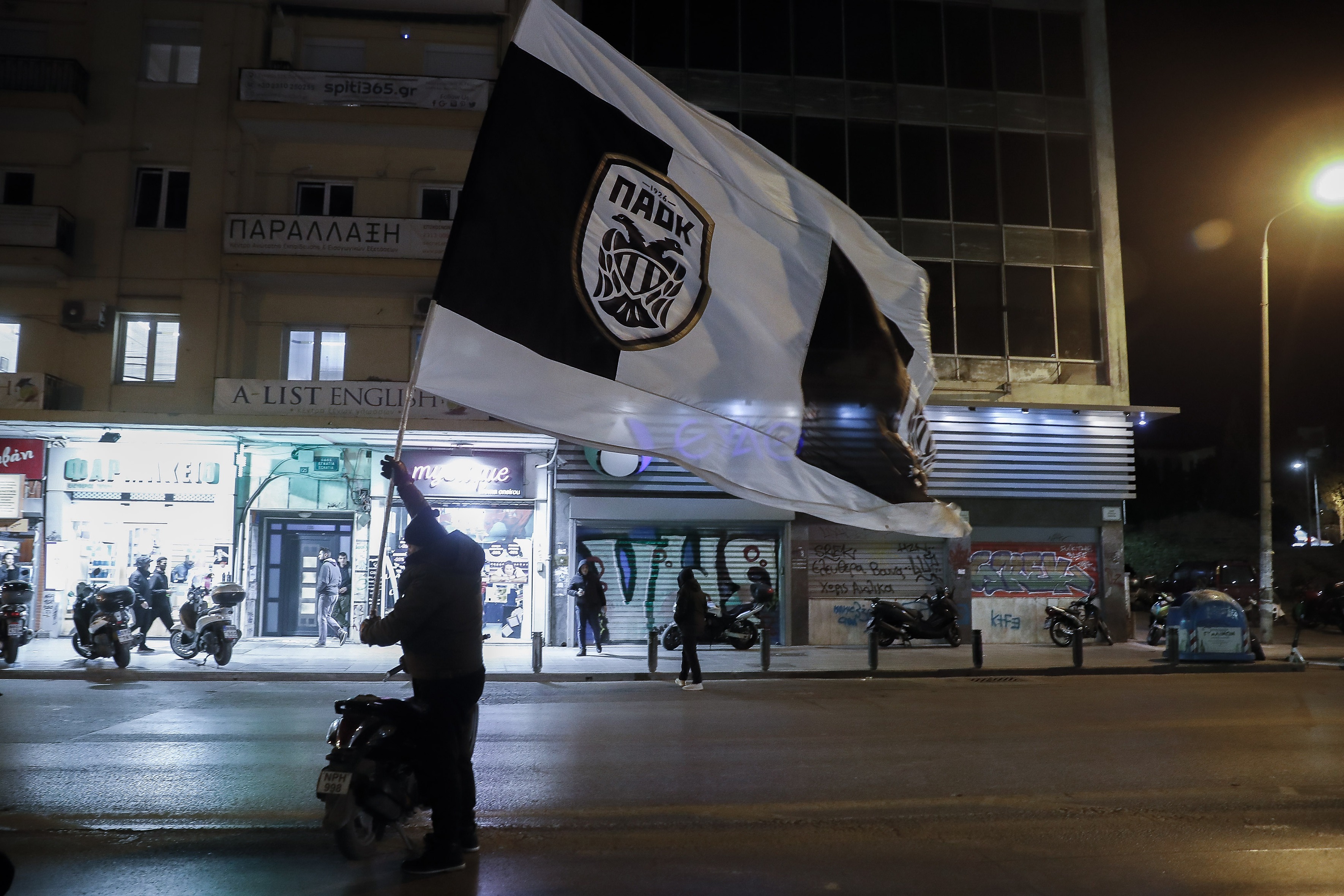 A fan holds a flag during PAOK FC supporters protest against the government, on the ocassion of the punishment for their team during an ongoing soccer scandal, Thessaloniki, Greece