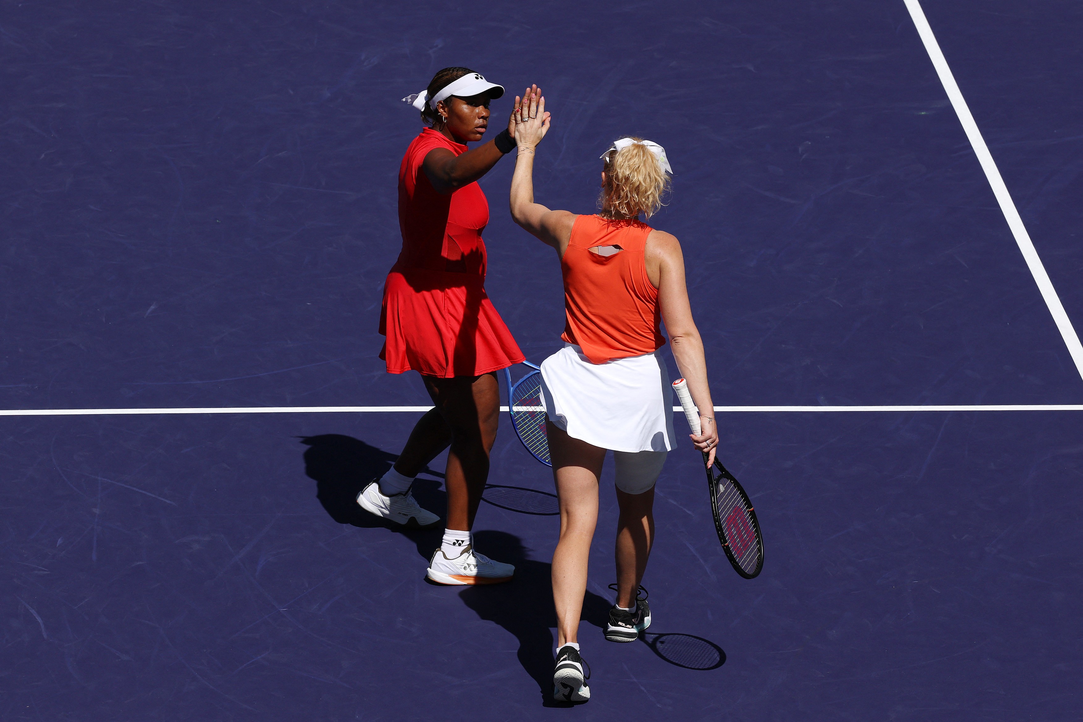 Taylor Townsend of the United States celebrates with partner Katerina Siniakova of Czechia against Anna Danilina of Kazakhstan and Aleksandra Krunic of Serbia during their Women's Doubles Finals match of the BNP Paribas Open at Indian Wells