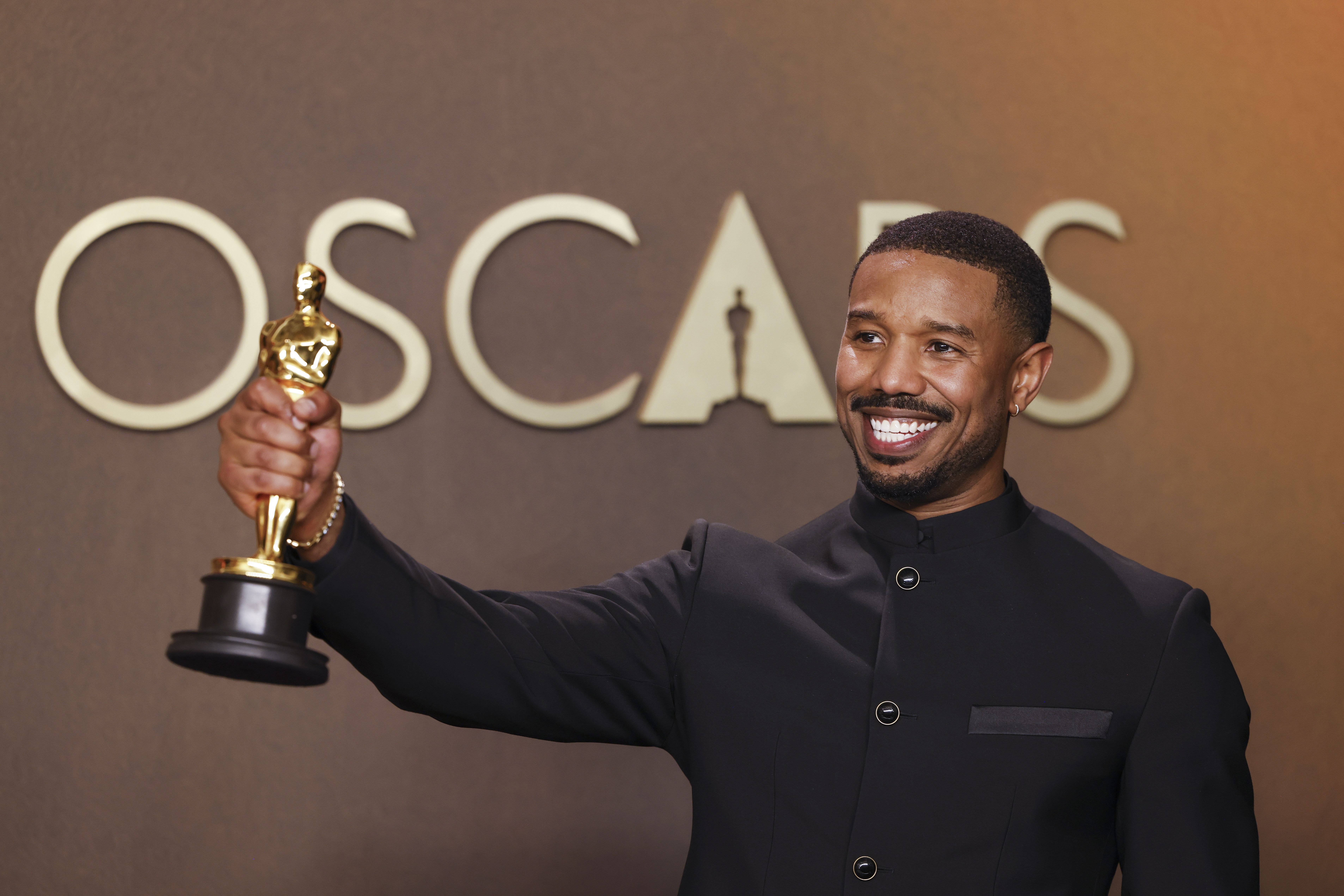 Michael B. Jordan, winner of the Best Actor Award for 'Sinners' poses in the press room