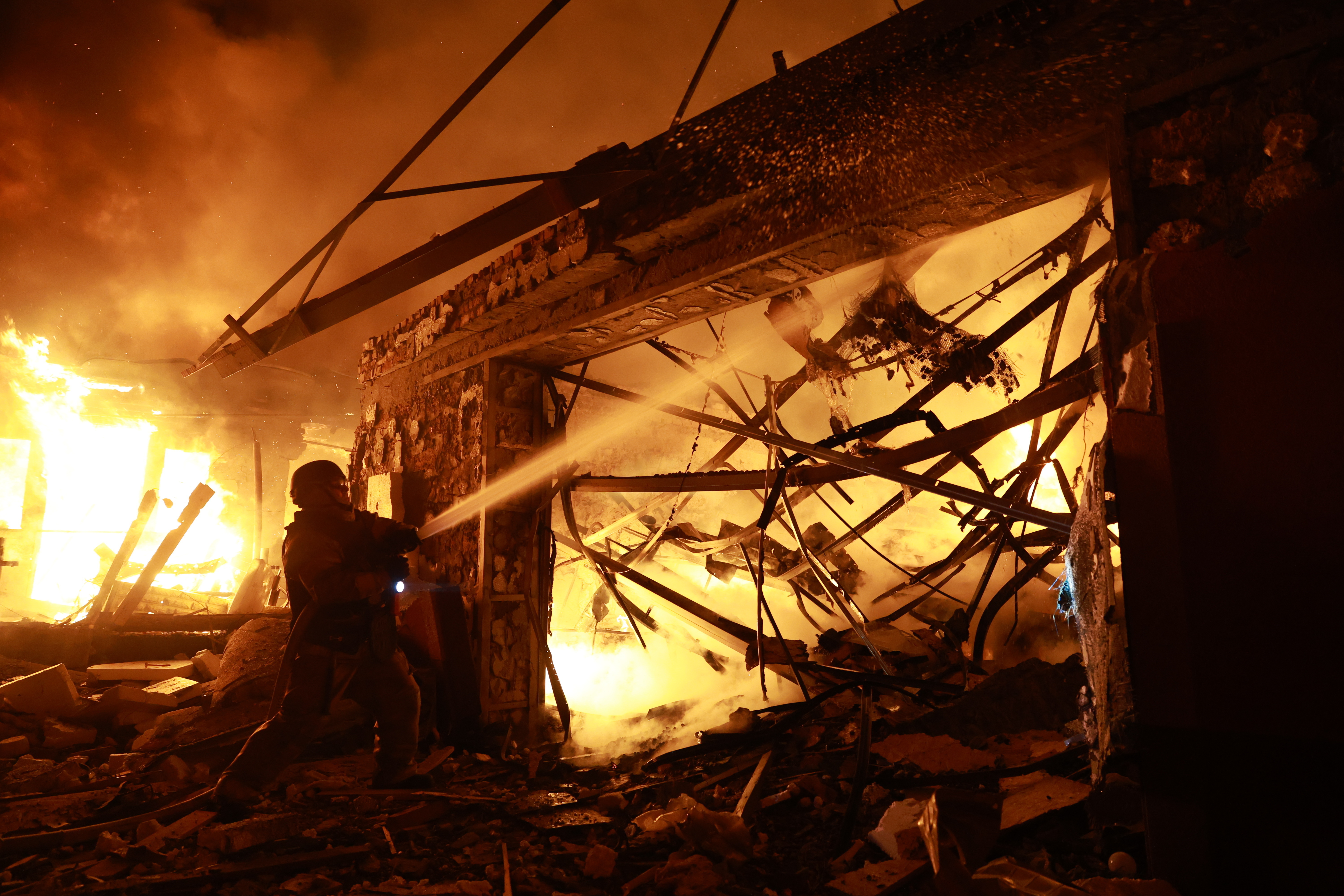 Firefighters try to put out a fire at a private house following a Russian drone attack in Zaporizhzhia, Ukraine, Monday, March 16, 2026. (AP Photo/Kateryna Klochko)