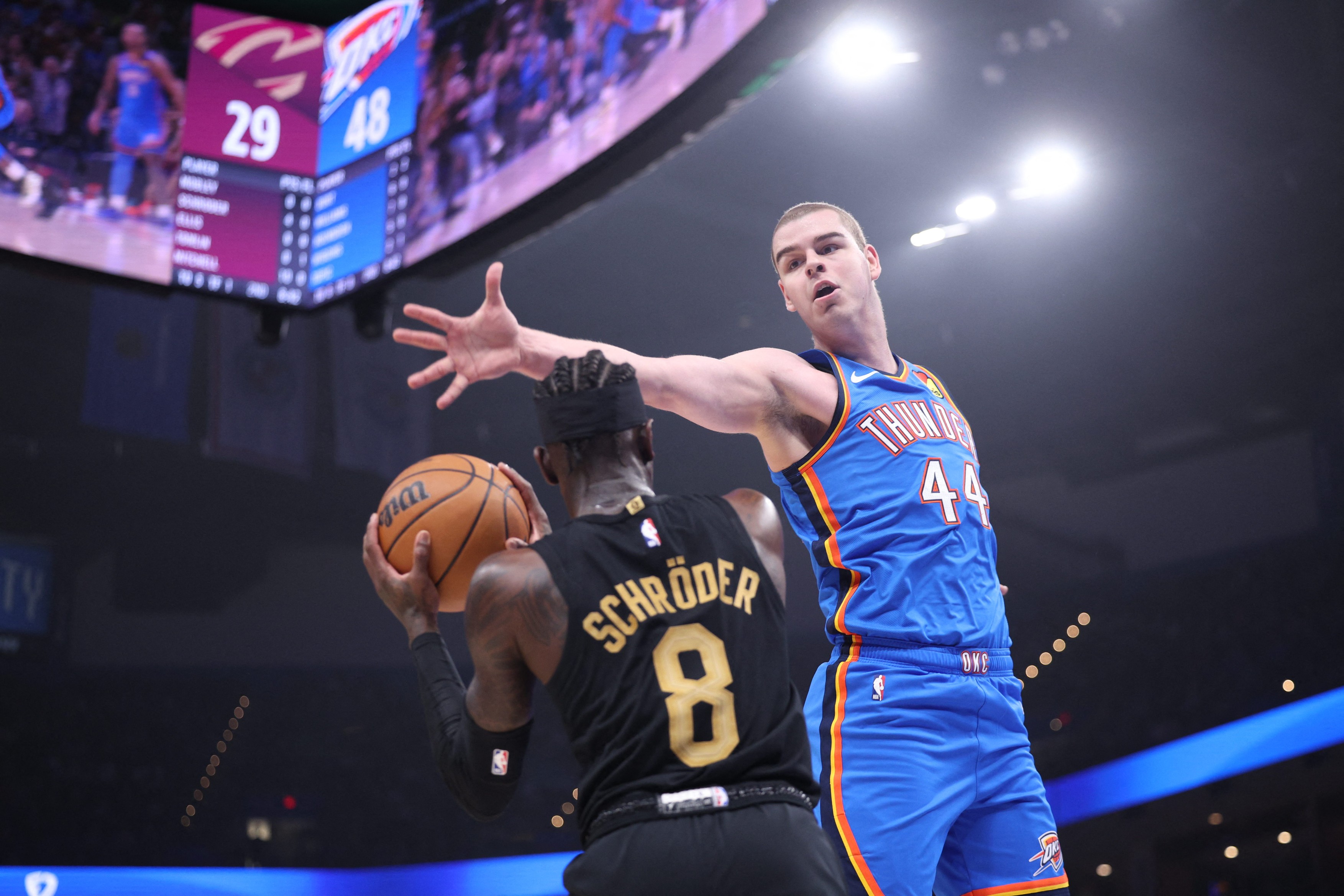 Nikola Topic #44 of the Oklahoma City Thunder blocks a shot by Dennis Schroder #8 of the Cleveland Cavaliers