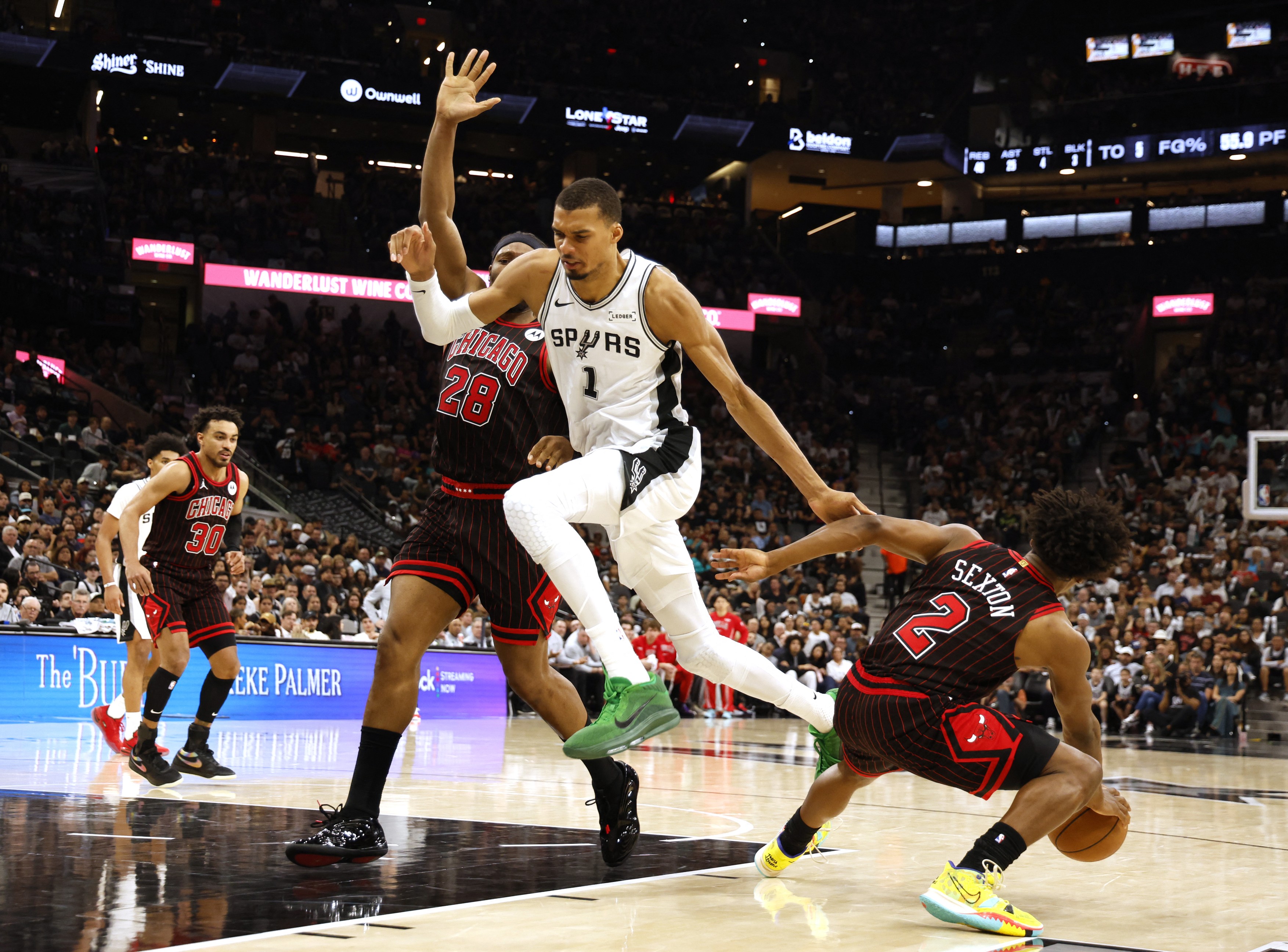 SAN ANTONIO, TX -MARCH 30: Collin Sexton #2 of the Chicago Bulls strips the ball from Victor Wembanyama #1 of the San Antonio Spurs